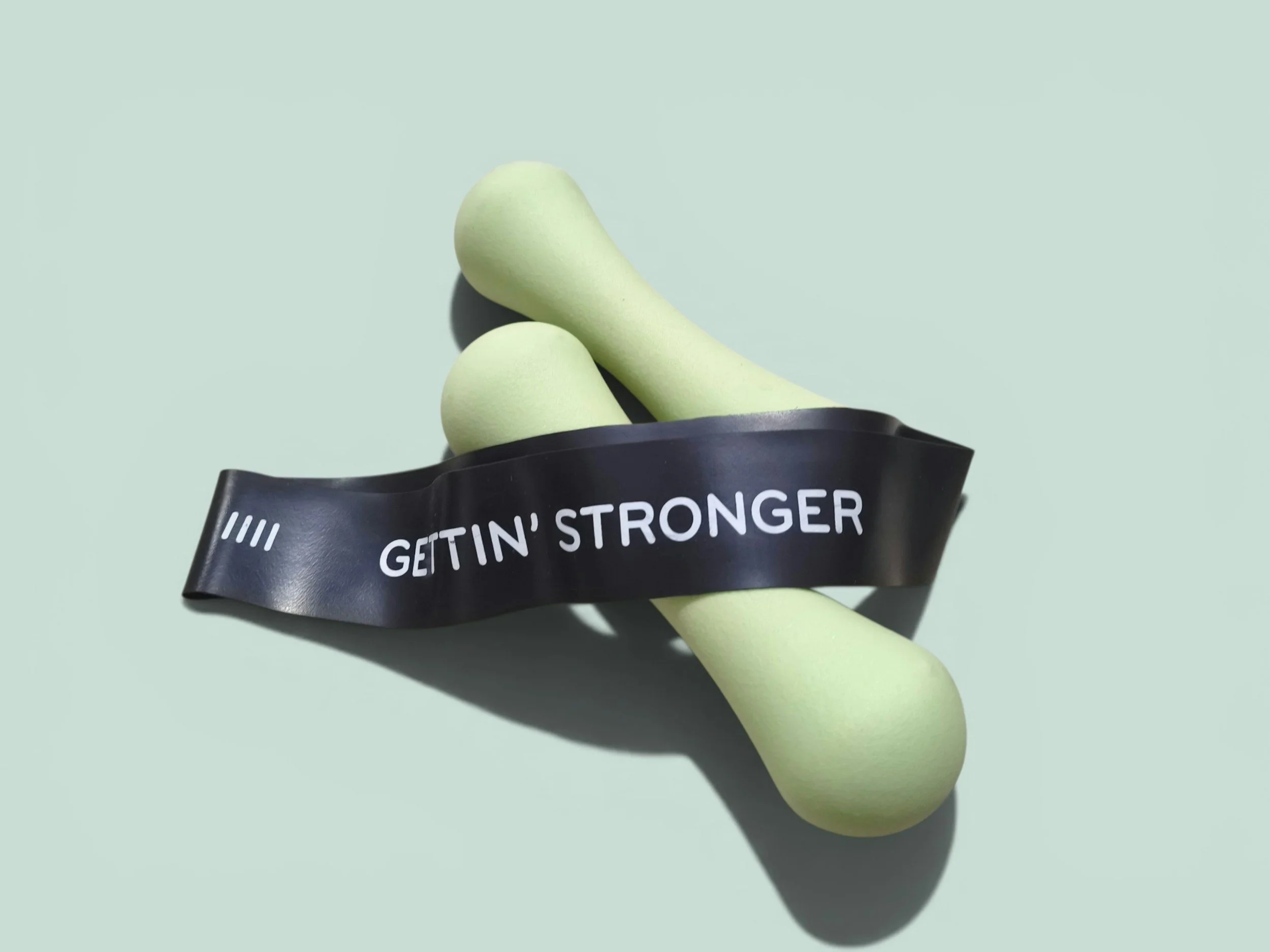 mini resistance band hanging over dumbbell
