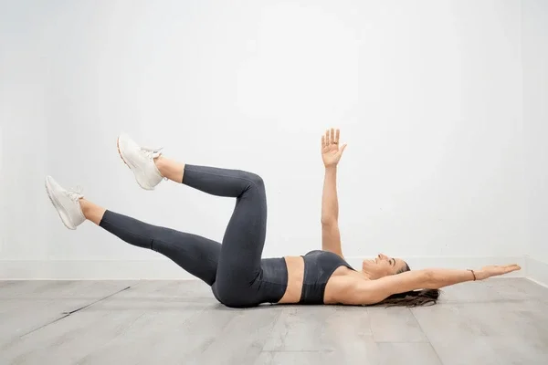 Woman performing dead bug exercise