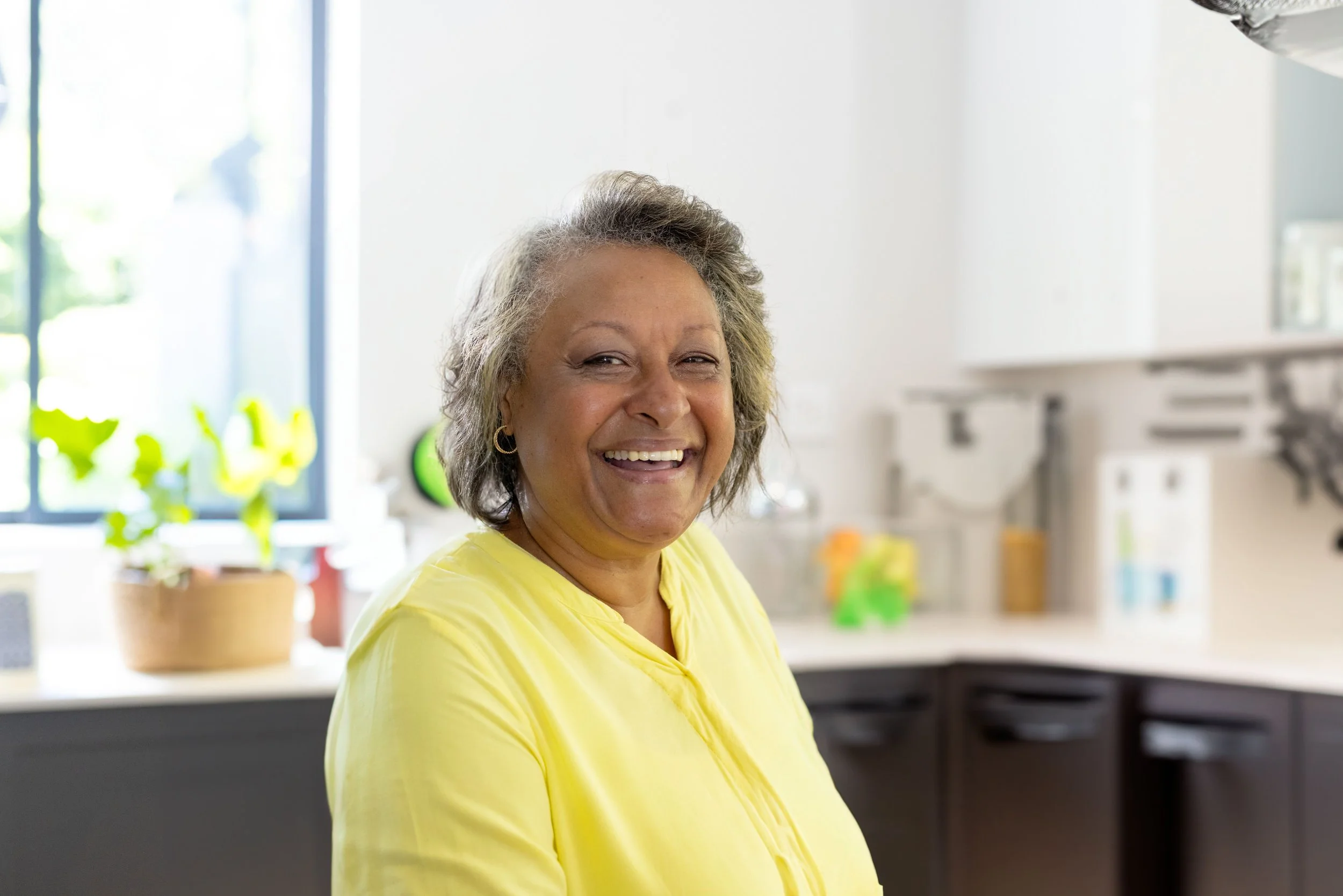 senior-woman-smiling-and-organizing-glass-jars-on-2025-10-08-11-27-05-utc.jpg