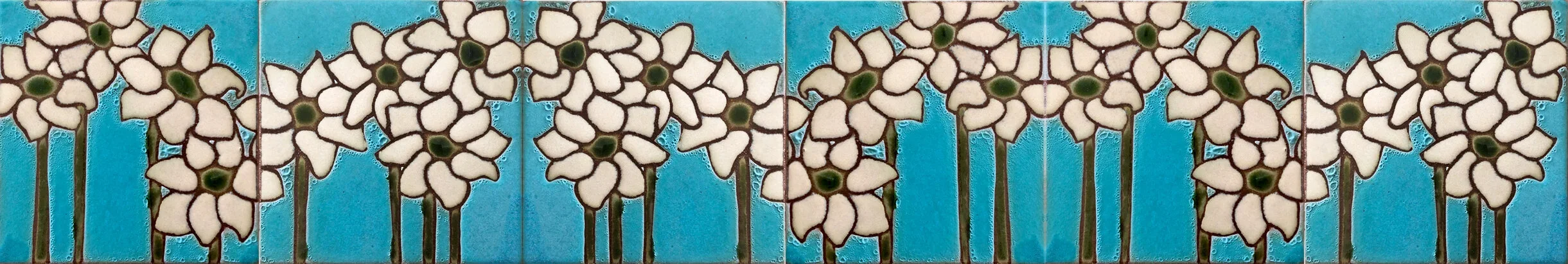 Decorative tile border with a pattern of cream flowers looking like notes on a sheet of music with dark centers and dark outlines, set against an aqua blue background.