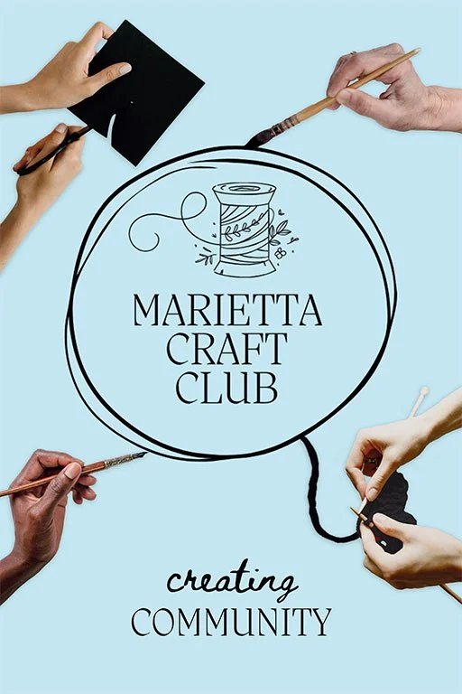 Hands of multiple people holding art supplies such as brushes and a black square, surrounding a logo for Marietta Craft Club with the slogan "creating community" on a light blue background.