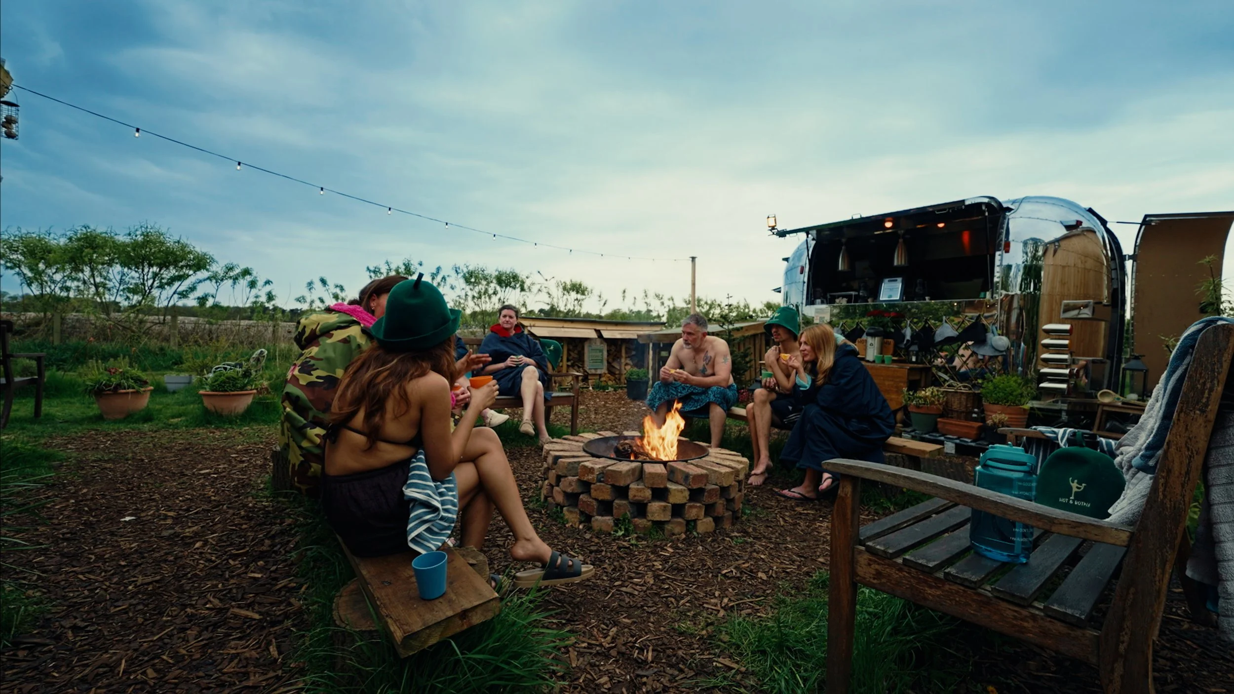 A group sitting round the firepit at Hot & Bothy having a chat.