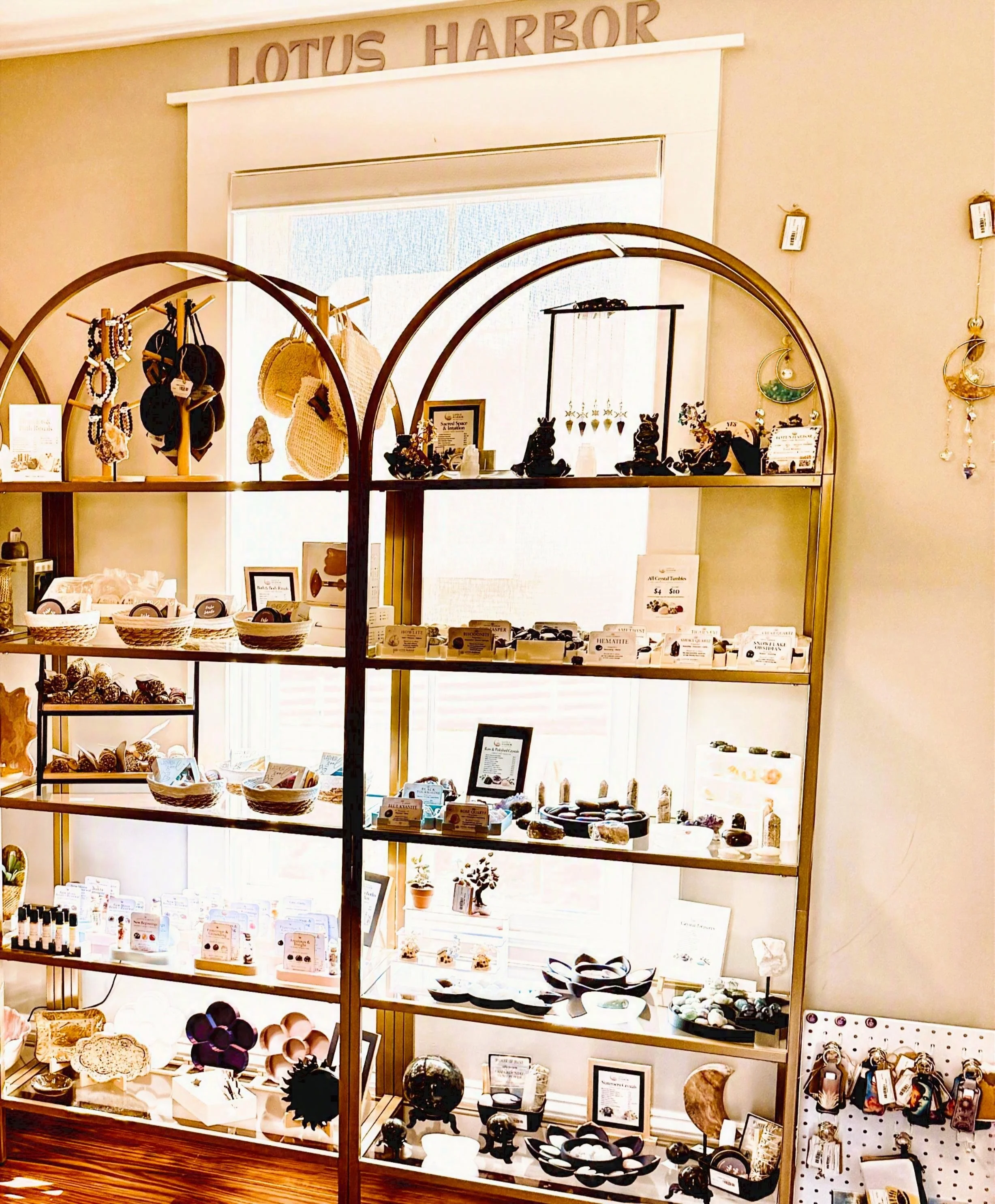 New Lotus Harbor shelves at Wood Wire & Whimsy filled with crystals, jewelry, and intentional gifts.