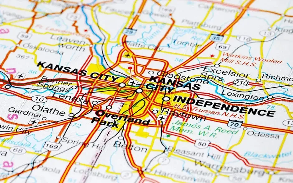 Map of Kansas City with highlighted neighborhoods including Kansas City, Independence, and Overland Park, showing roads, highways, and landmarks.