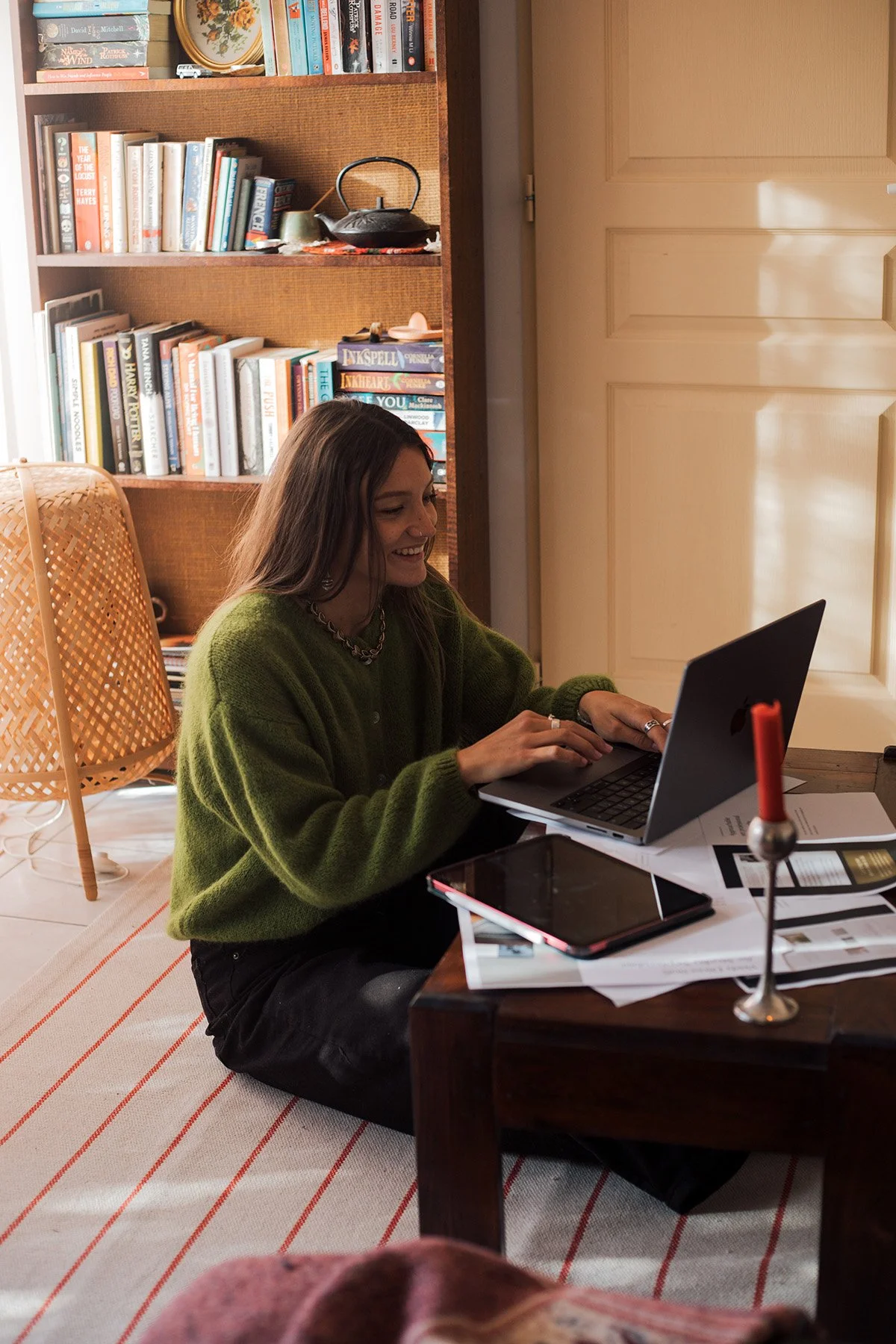Hannah, founder of Studio Meraki, sitting by the river near her home in France — where much of her creative inspiration begins border