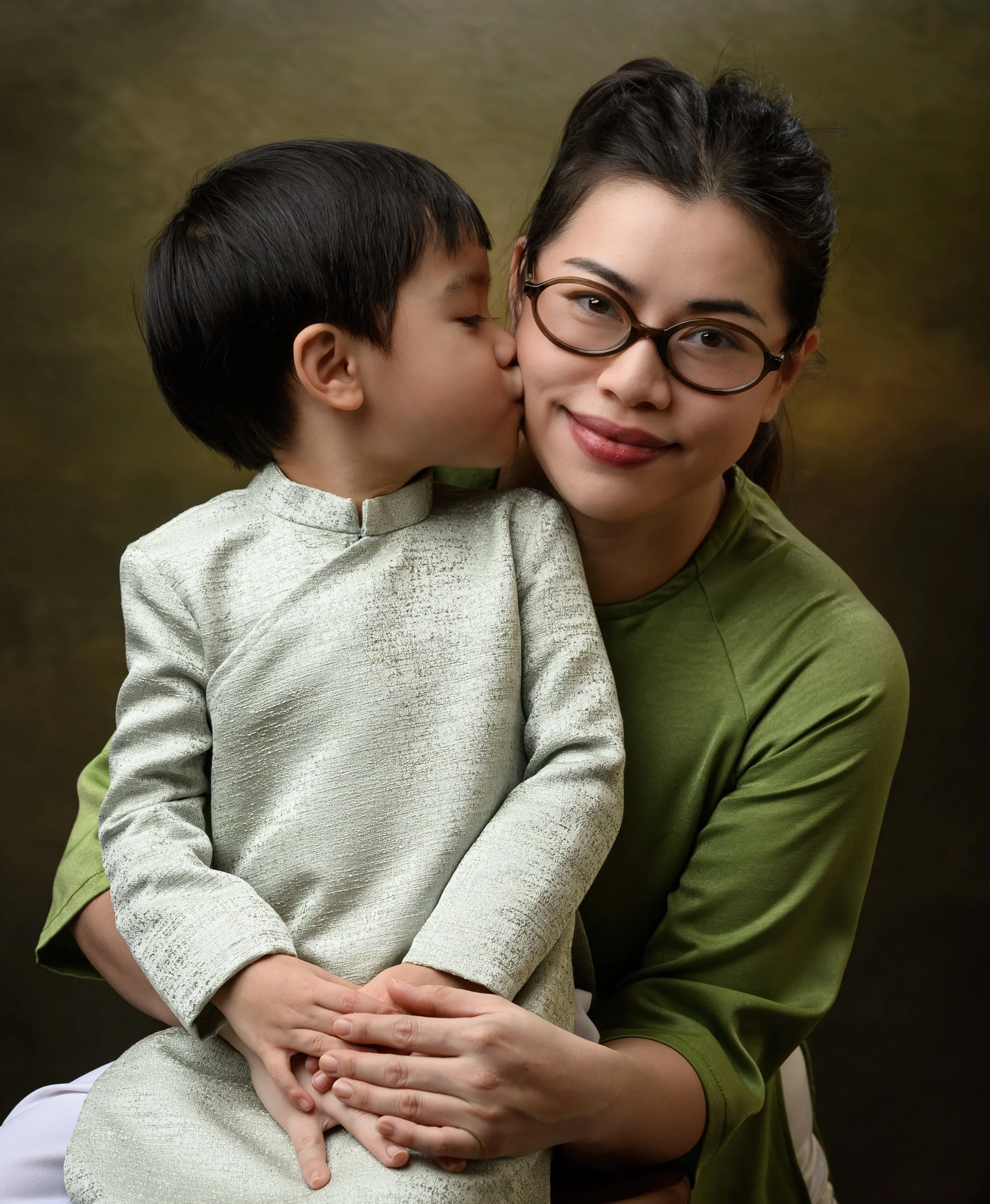 Mother and son embracing in a softly lit studio family portrait in Winter Garden, Florida