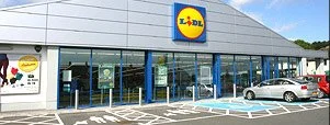 Lidl grocery store with glass front and parking lot