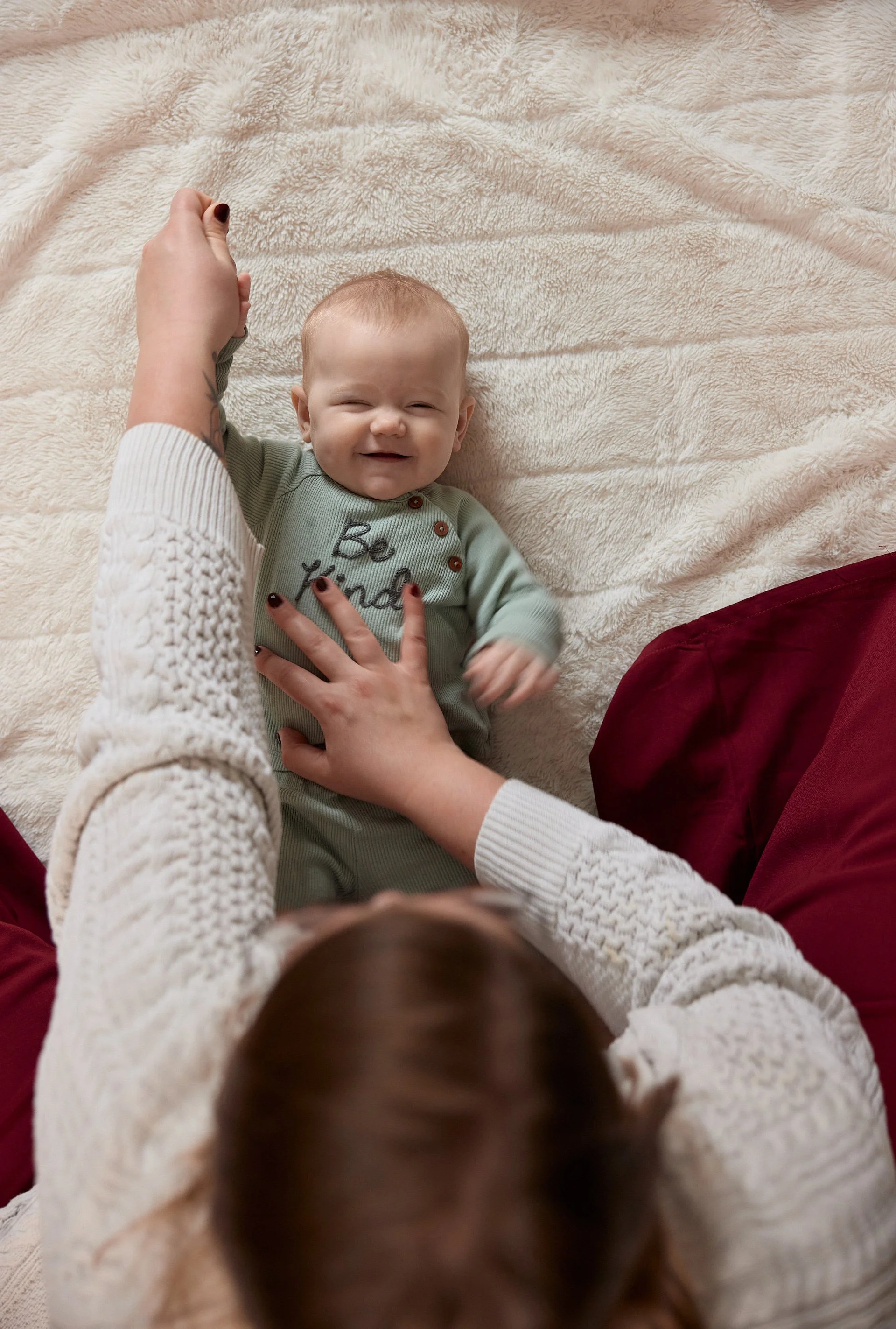 Infant Massage therapy shows the benefit of infant massage stretching baby to make them happier in tummy time