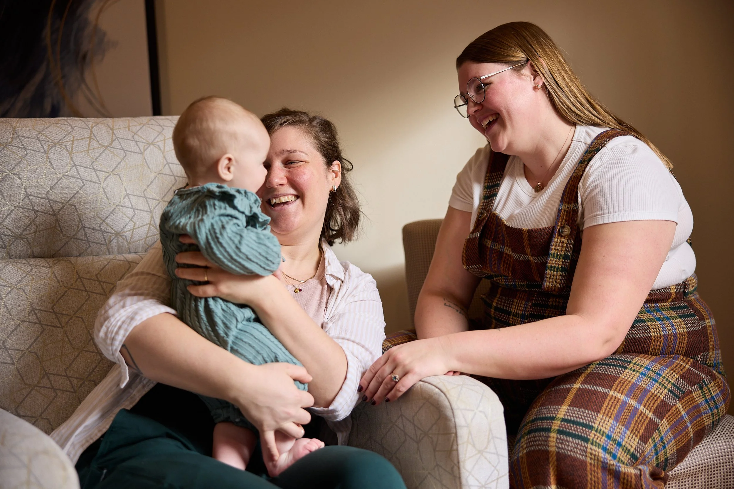 Lactation Consultant with smiling mom and baby after receiving in home lactation support in Ontario