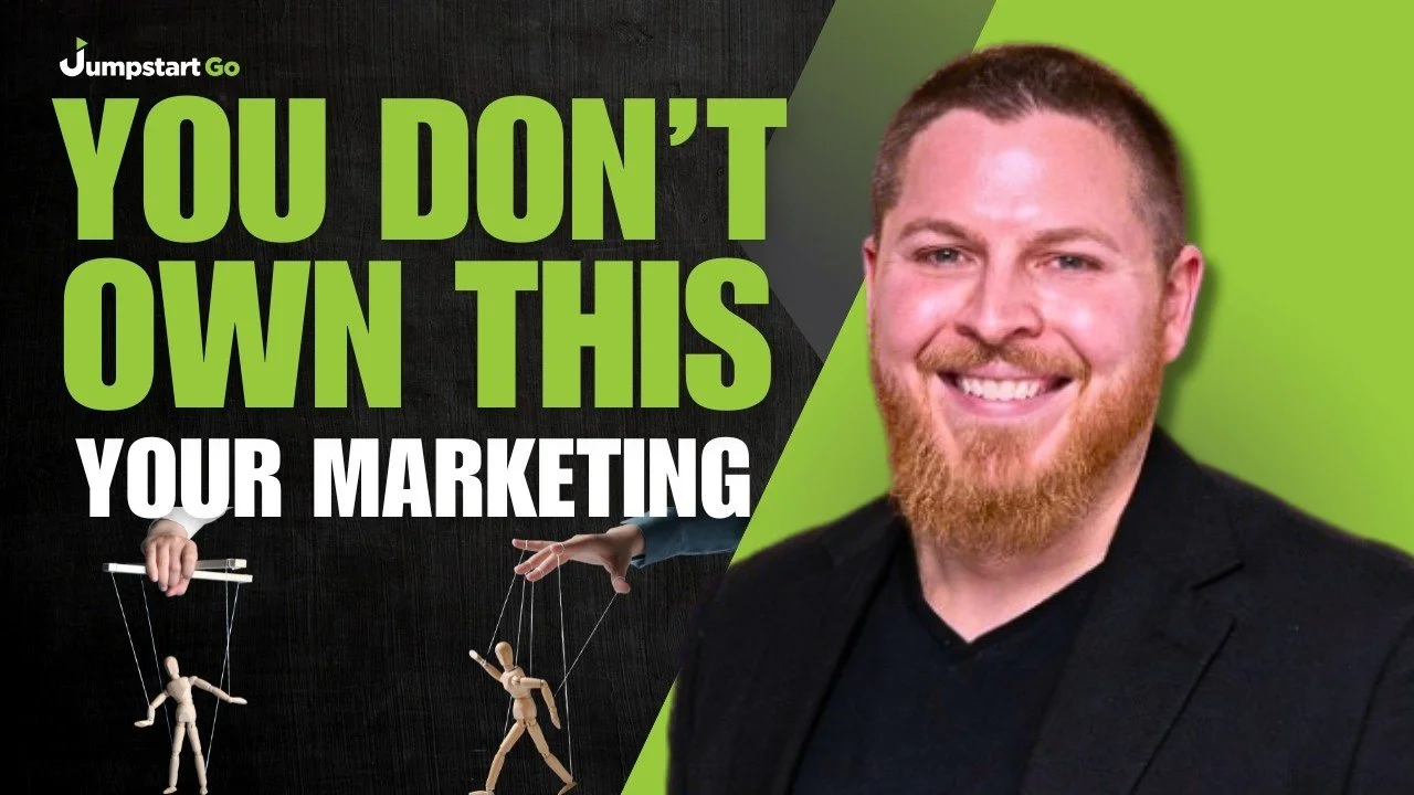 Promotional graphic with a man smiling, wearing a black blazer, against a green background. Text reads "You Don't Own This Your Marketing" with additional branding "Jumpstart Go" and images of marionette puppets.