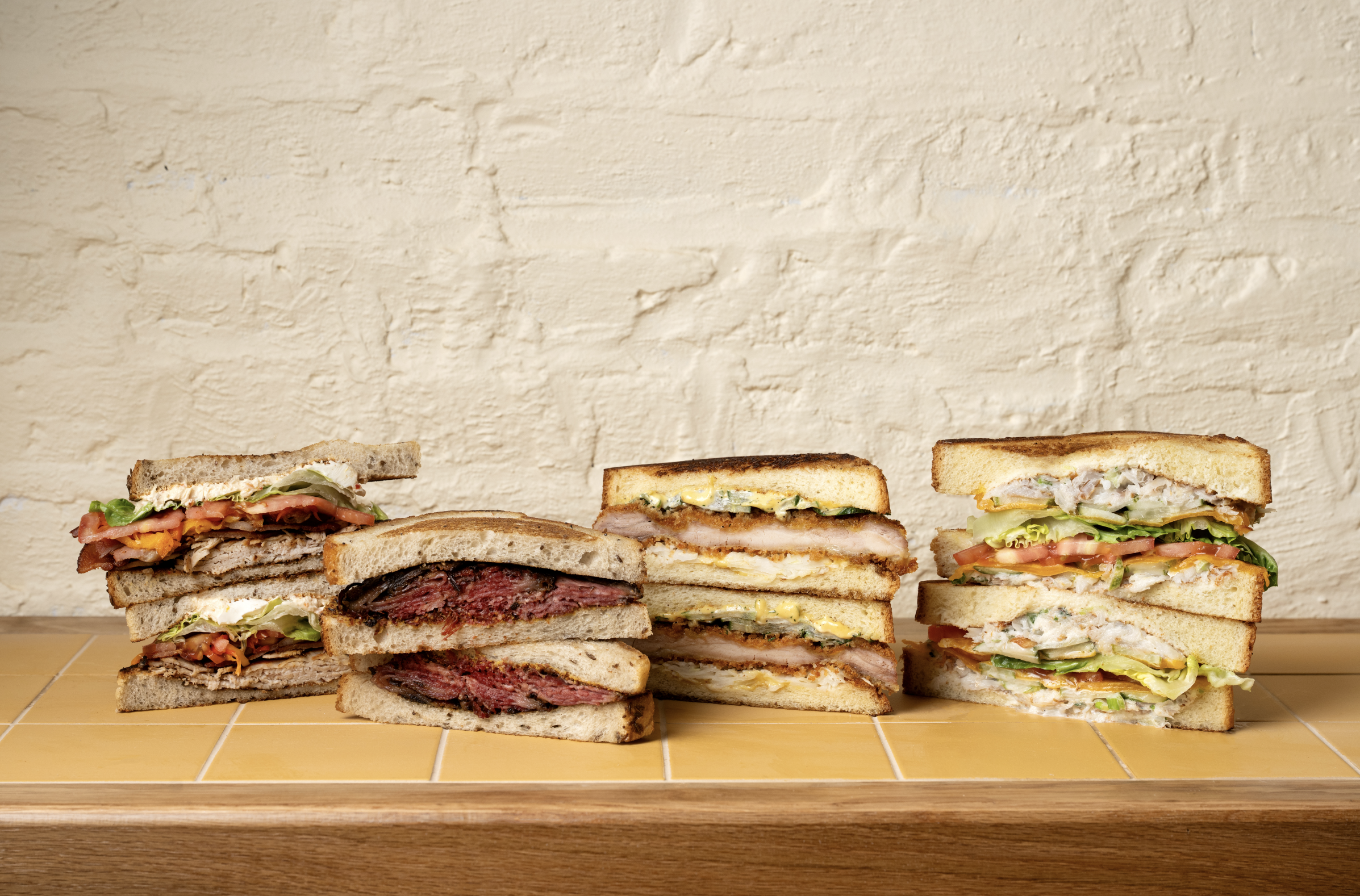 GERTIE sandwiches, including pastrami on rye, chicken schnitzel, turkey club, and chicken salad sandwich