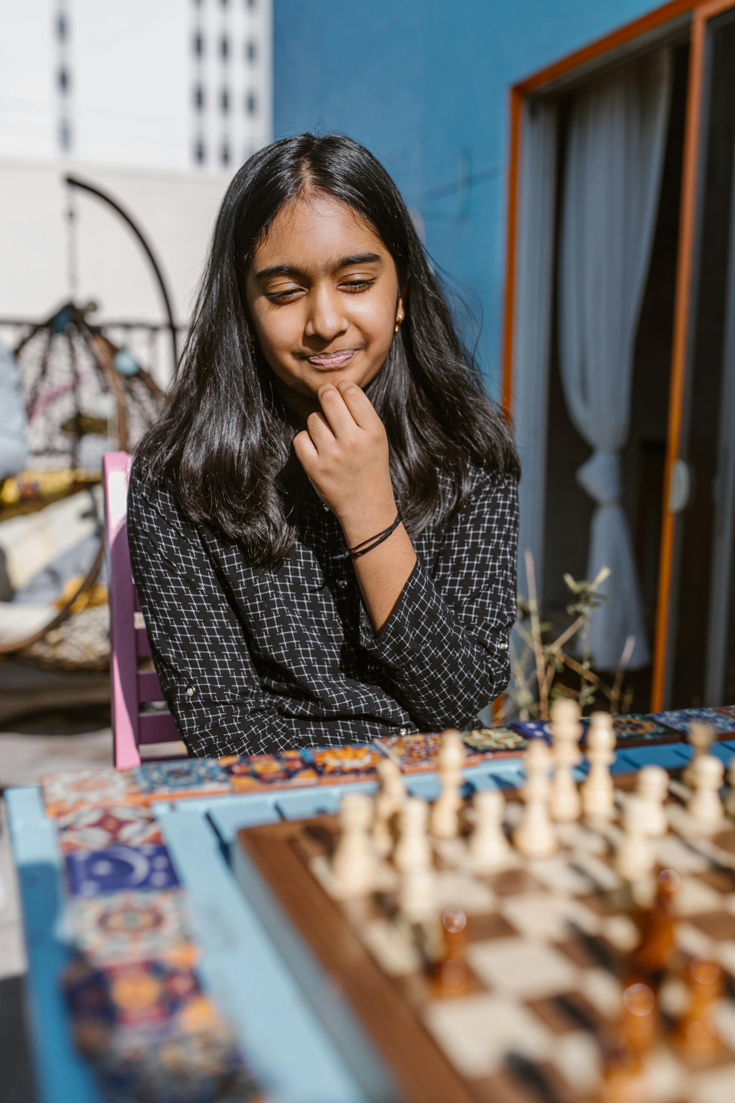 Young chess player studying a position at the board