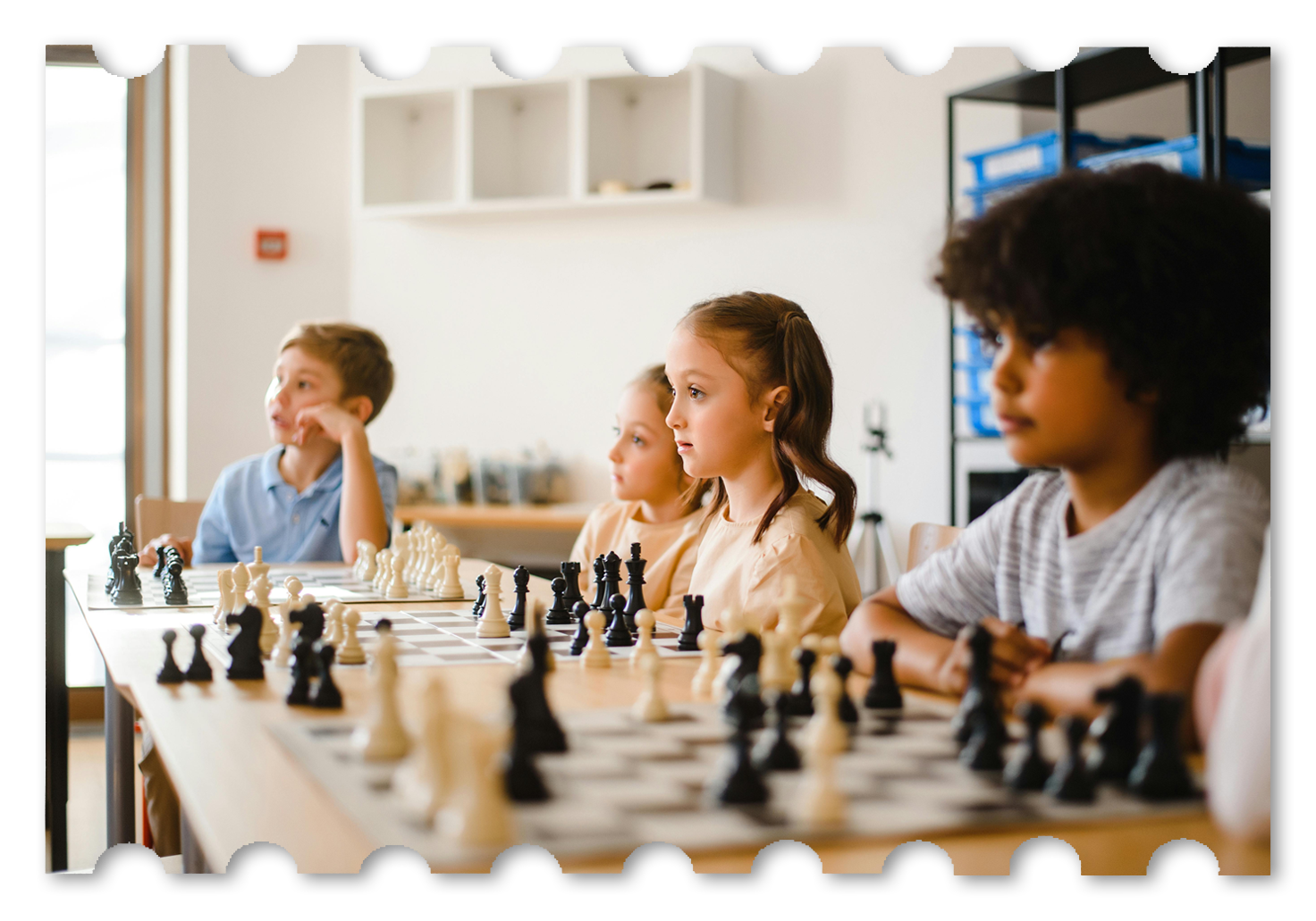 Young chess students learning together in a classroom