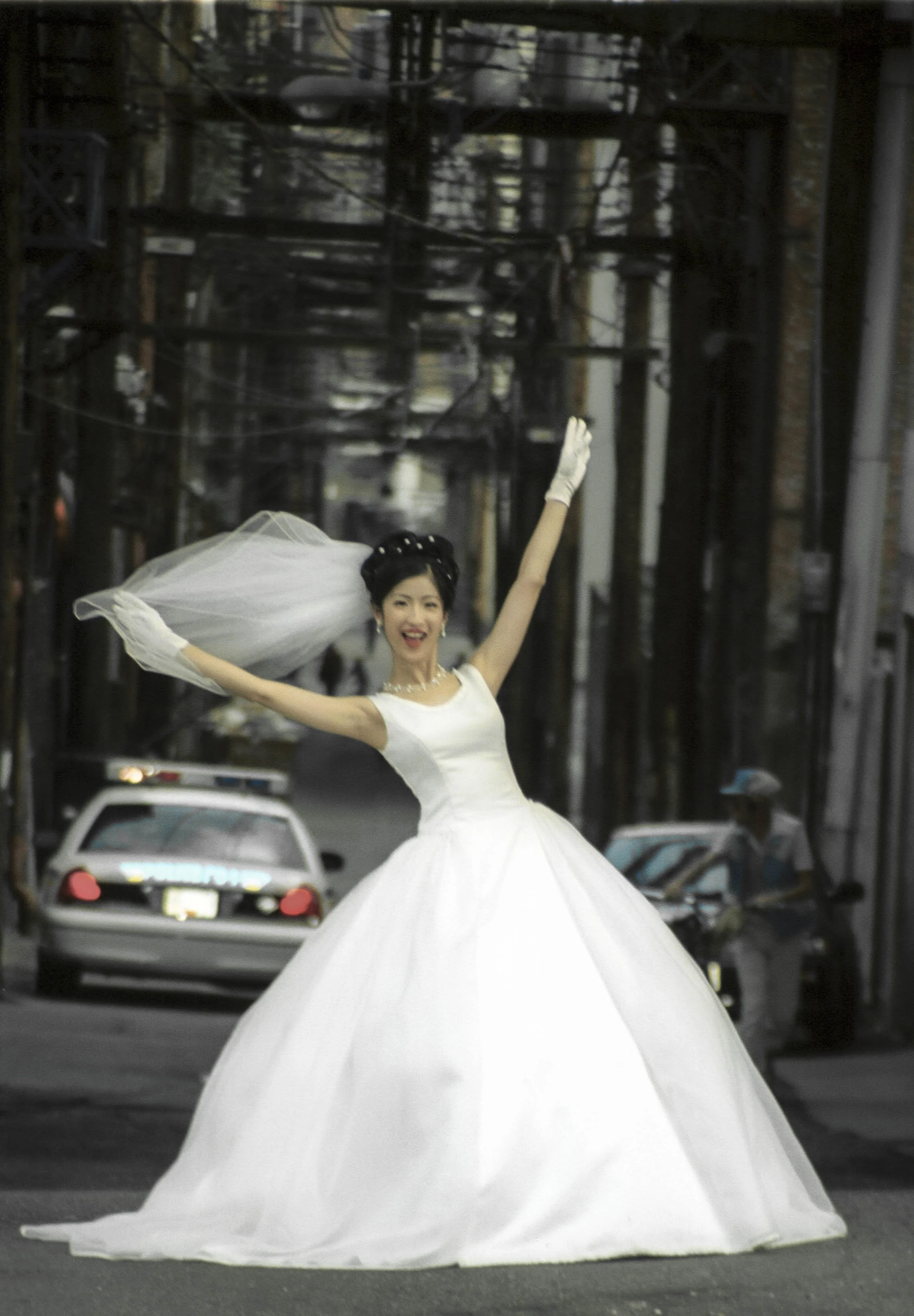 Wedding photo with police car in the alley