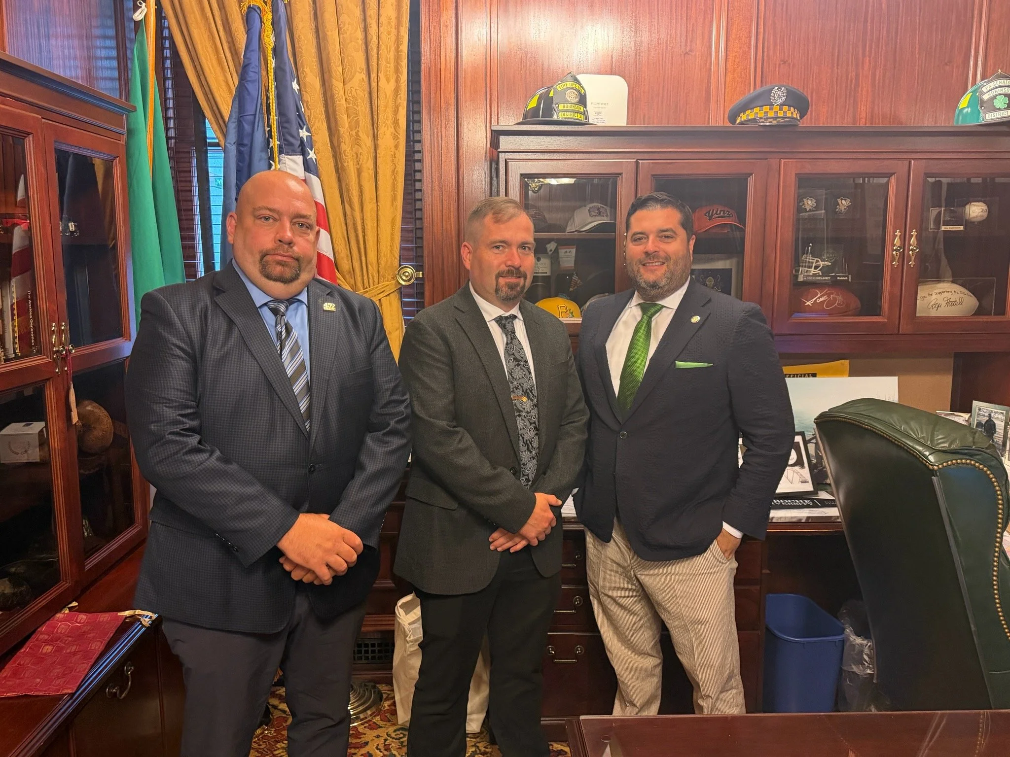 Aric Baker (IBEW Local 459) and Travis Beck (UWUA System Local 102) with Senator Devlin Robinson (R)