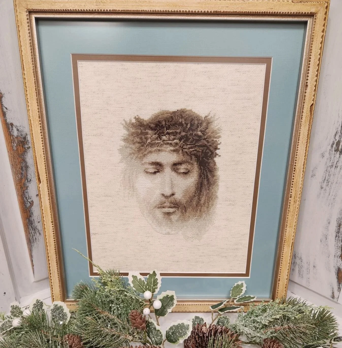 Religious cross-stitch framed with double mat