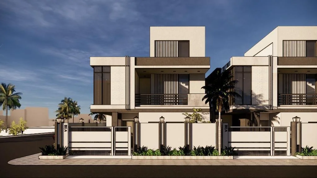 Modern two-story residential building with a white facade, black railings, and large windows, surrounded by a white fence with black accents and landscaping, featuring palm trees and a sidewalk in front.