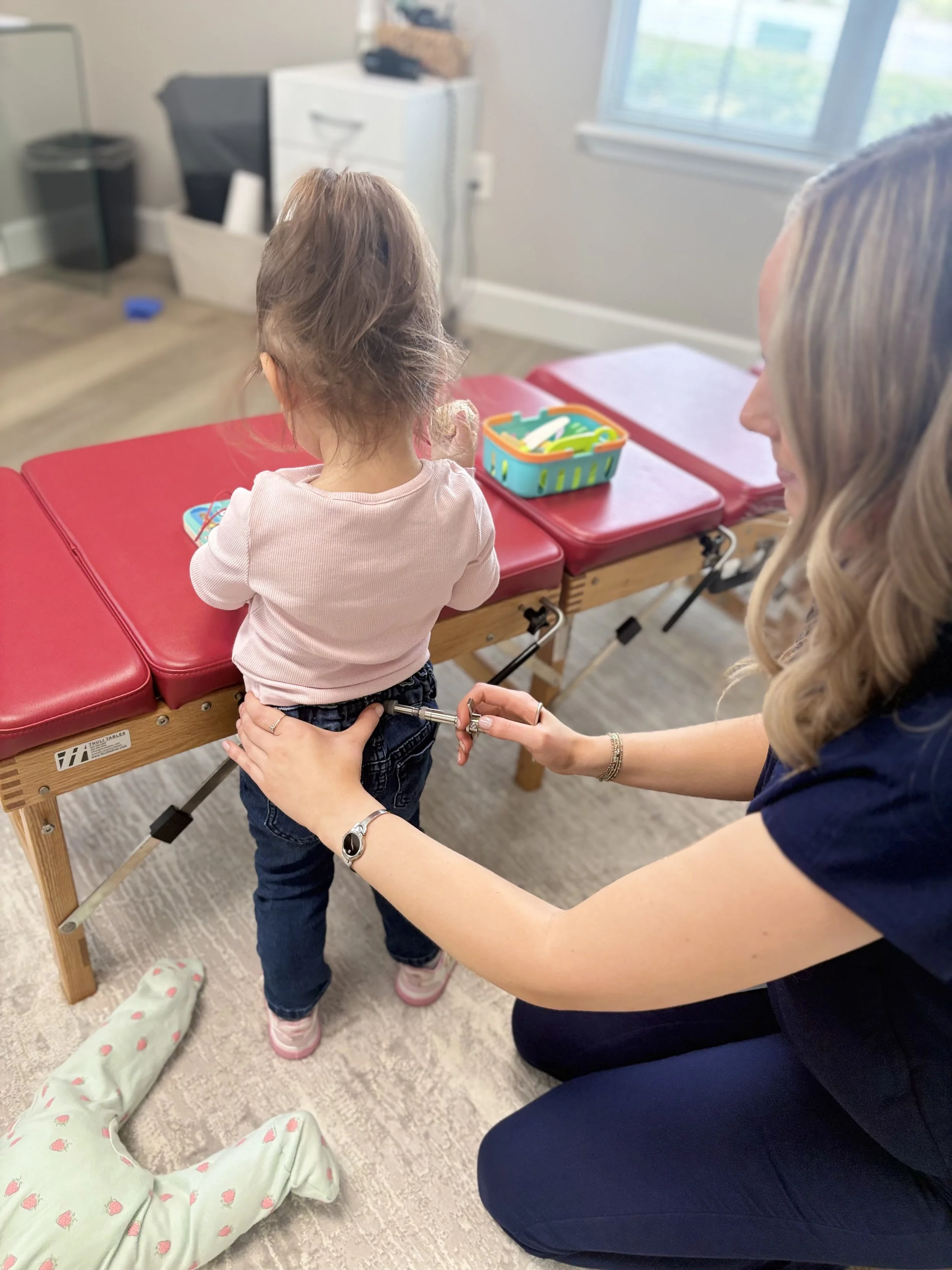 Pediatric sacral adjustment using an Activator