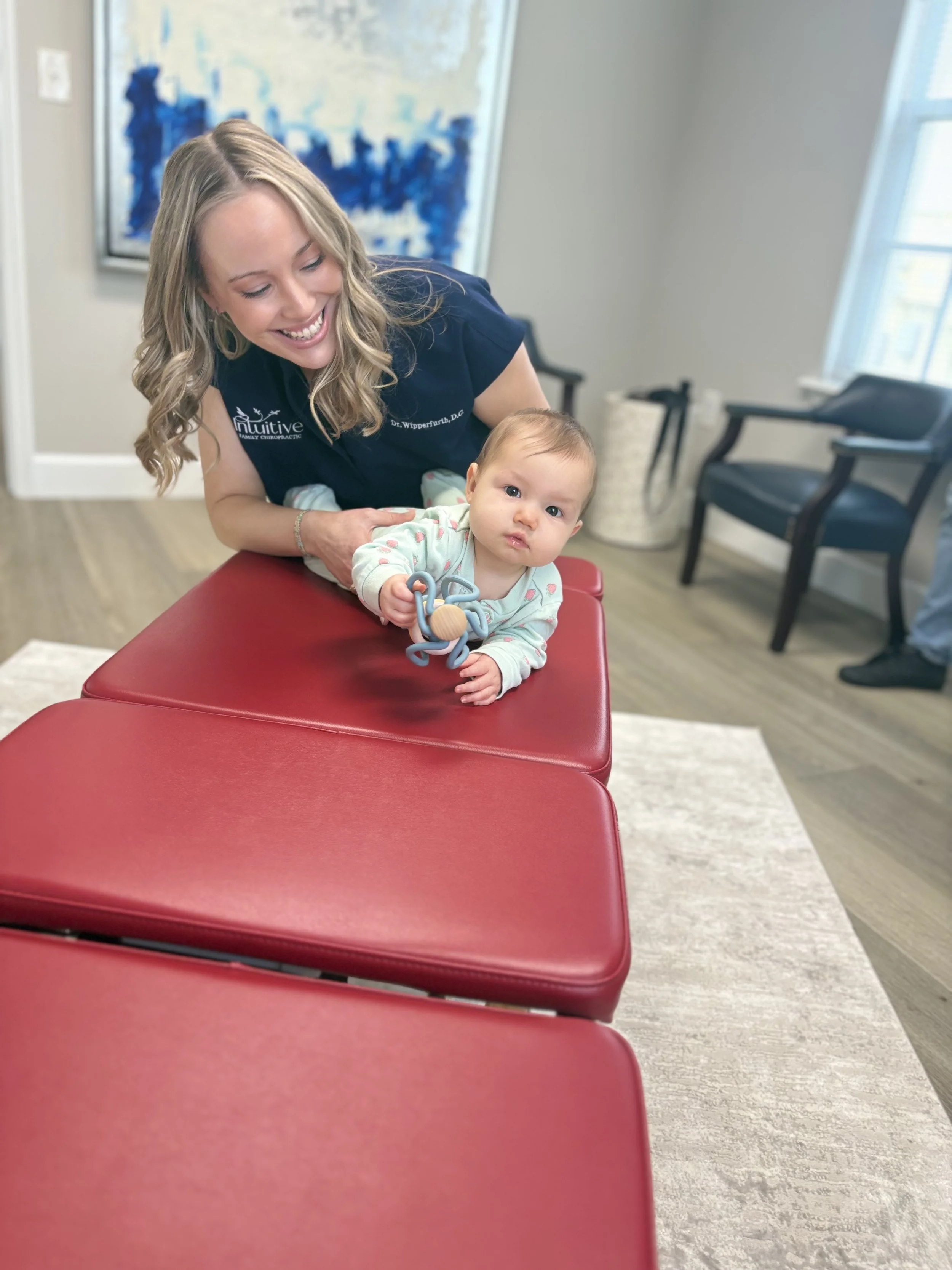 Dr. Wipperfurth performing a pediatric sacral adjustment