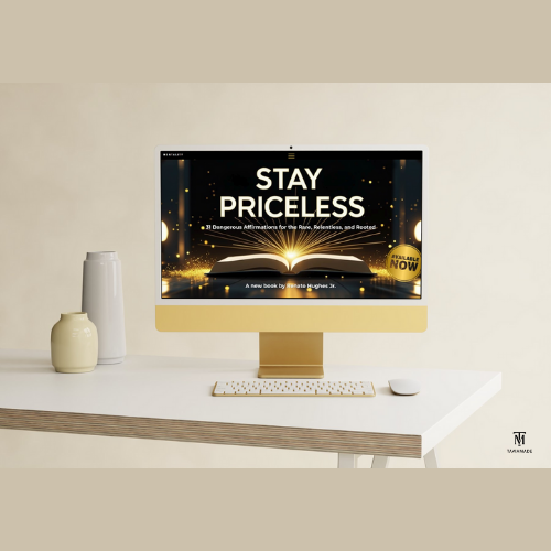 Computer monitor displaying the words 'STAY PRICELESS' with an open book and glowing effects, on a white desk with vases and a keyboard.