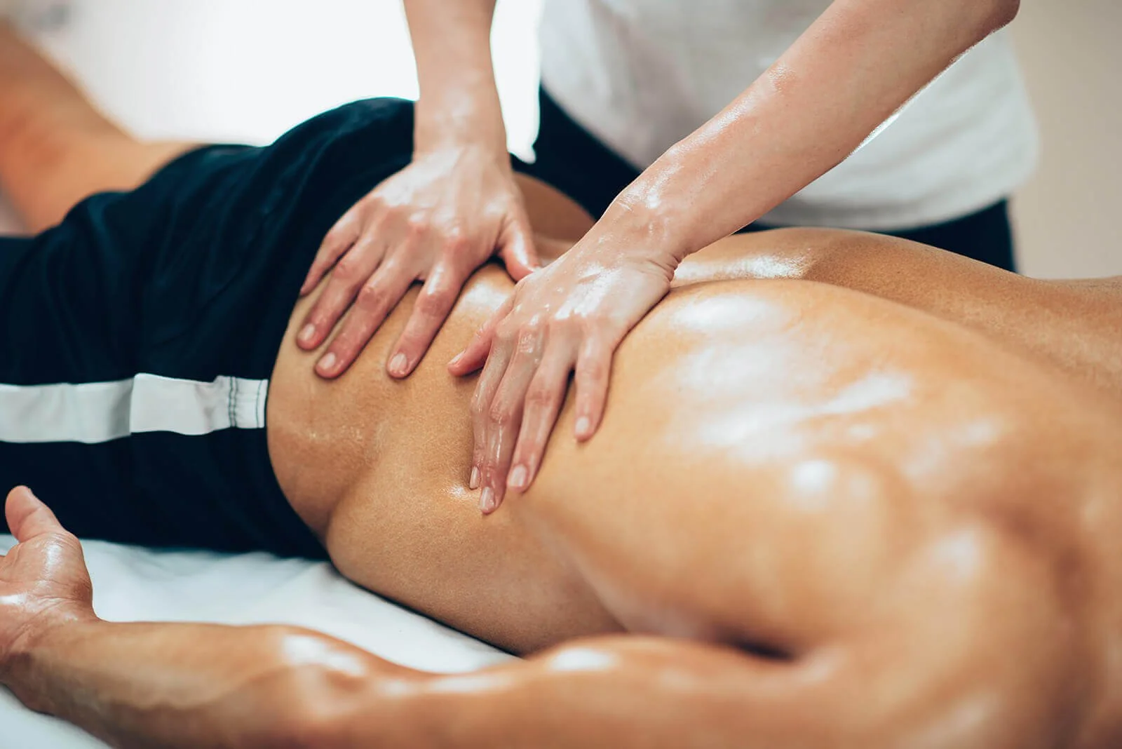 Person receiving a back massage from a massage therapist.