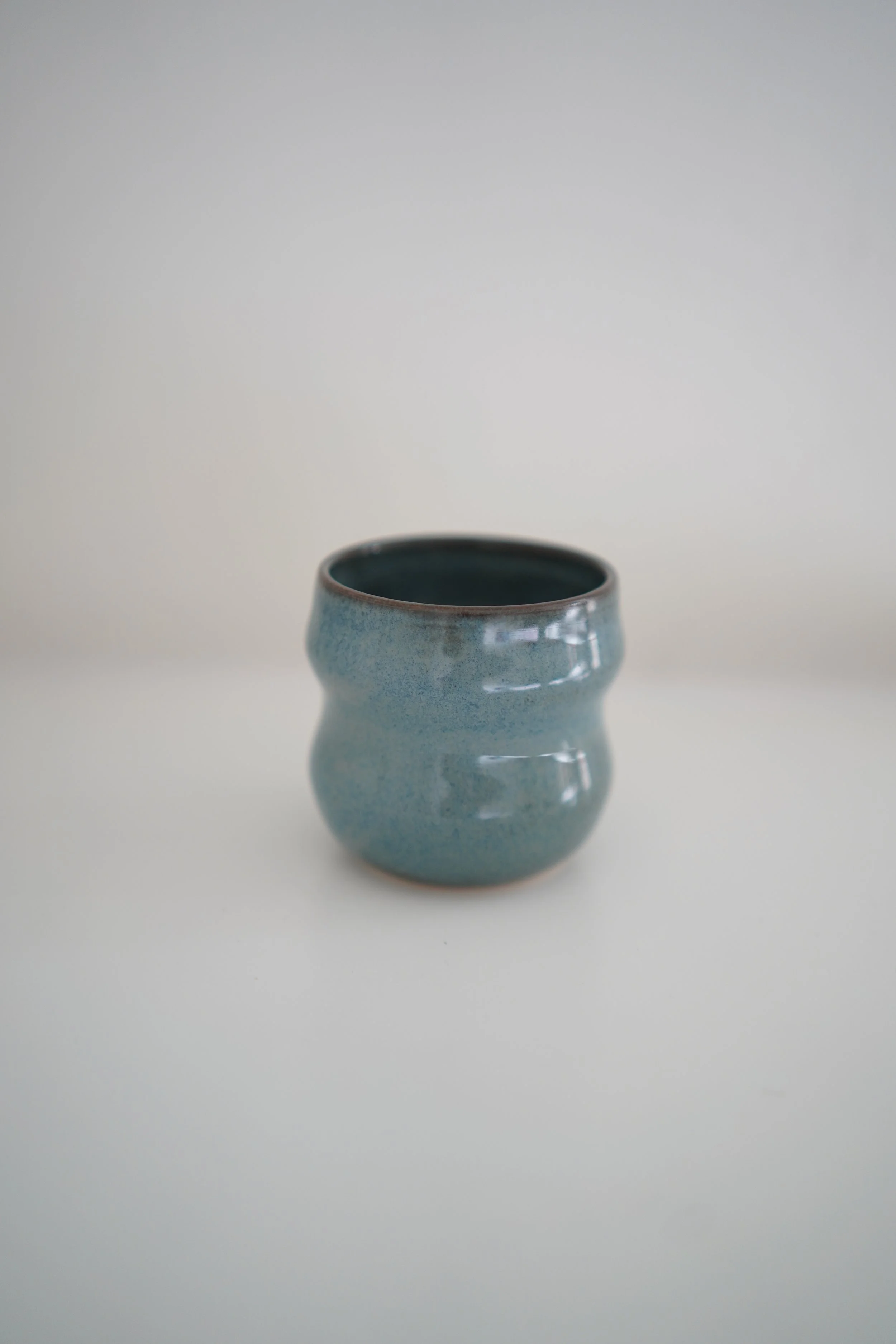 Handmade Curvy Floating Blue Ceramic Cup
