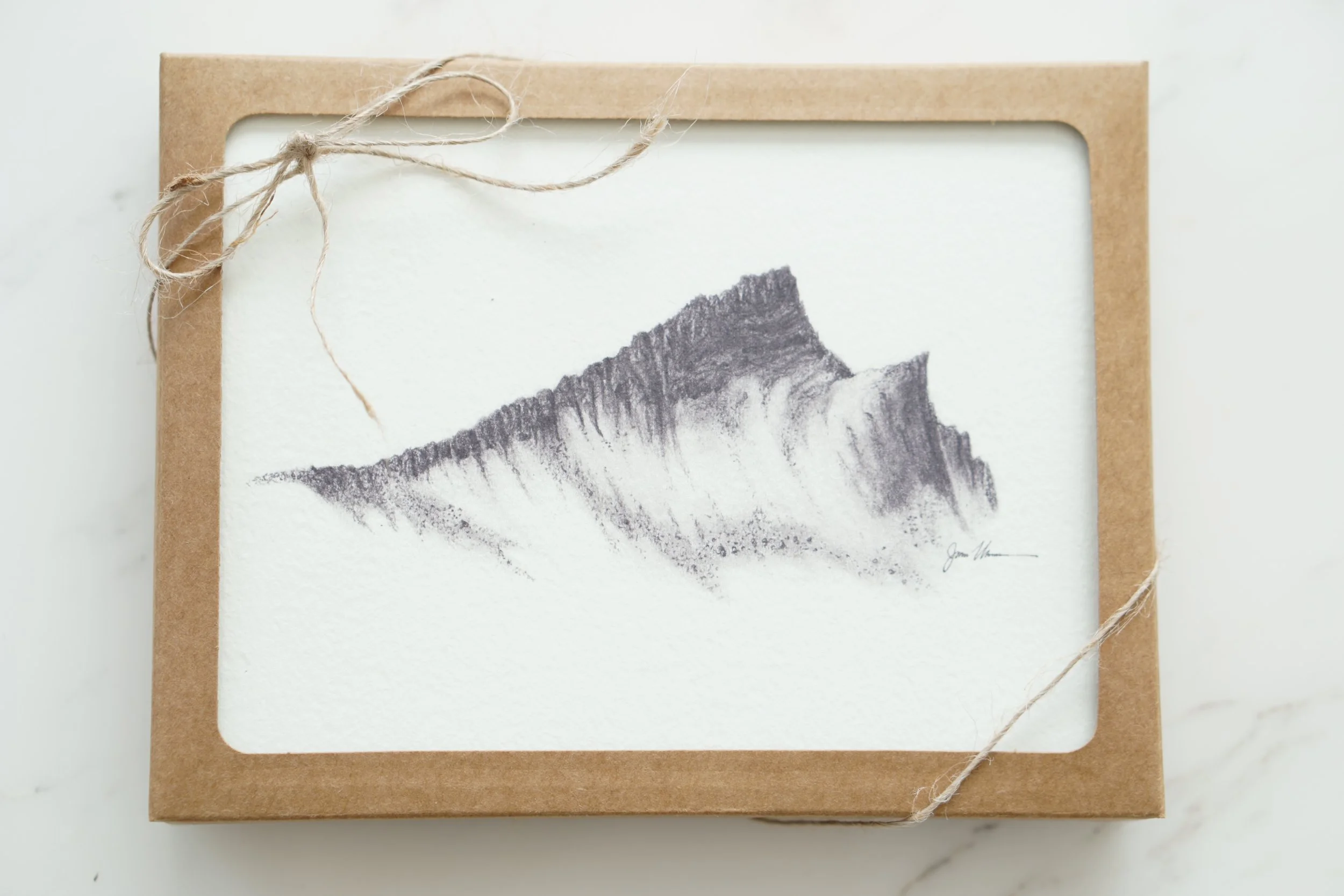 Curtis Gilbert Peak mountain illustration on cream stationery in a kraft gift box tied with twine.