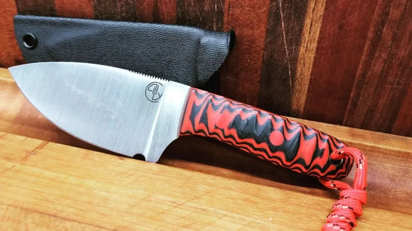 first knife I made. 1084 with G10 handle. Kydex sheath. That line is because only the sharp part is hard. makes the knife stronger and was in now way intentional.