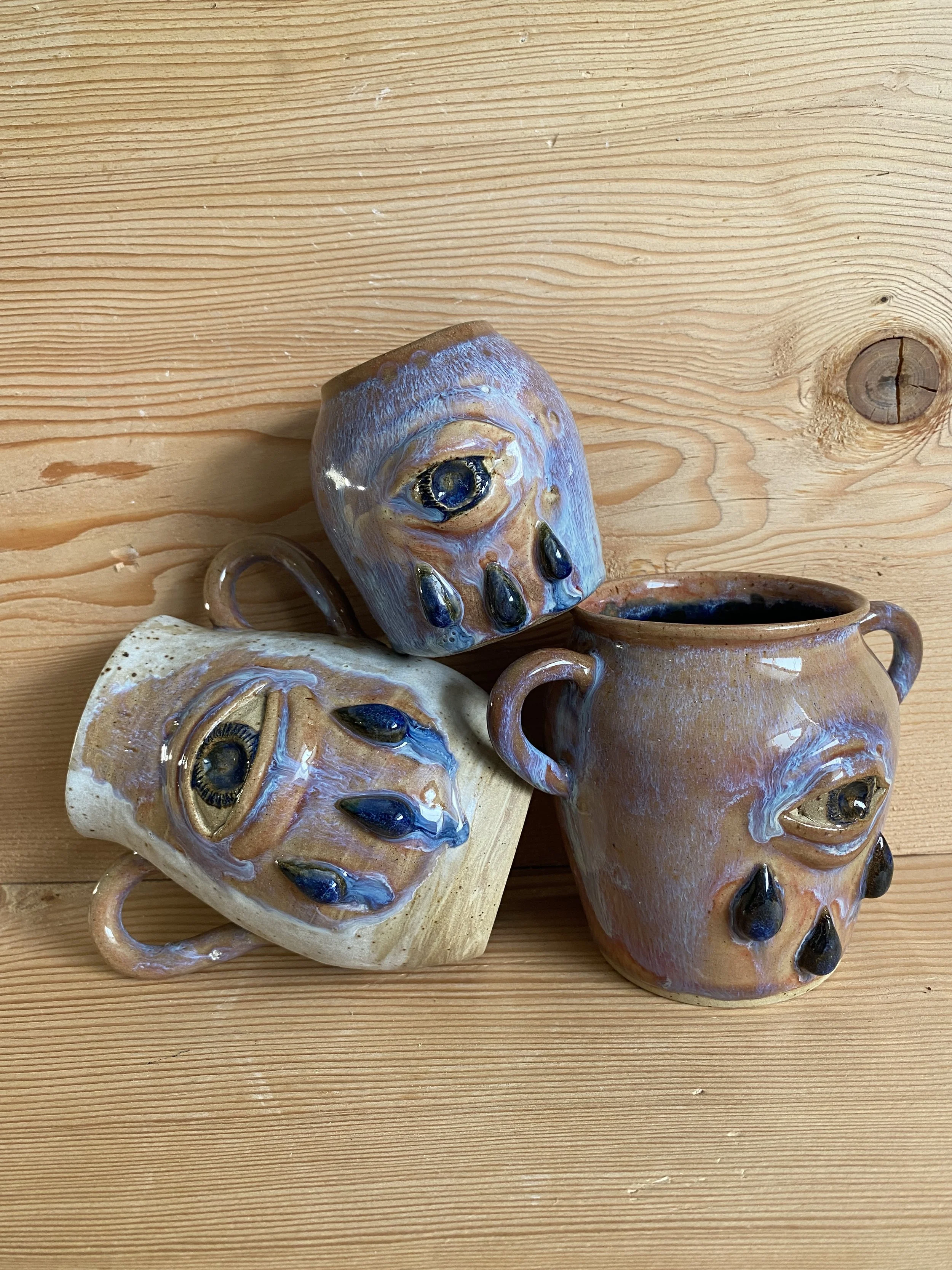 Ceramic vases with pink glaze and spiritual eyes with tears