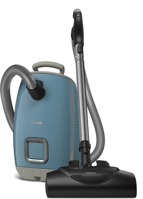 A Miele vacuum cleaner with a blue body and a black floor nozzle.