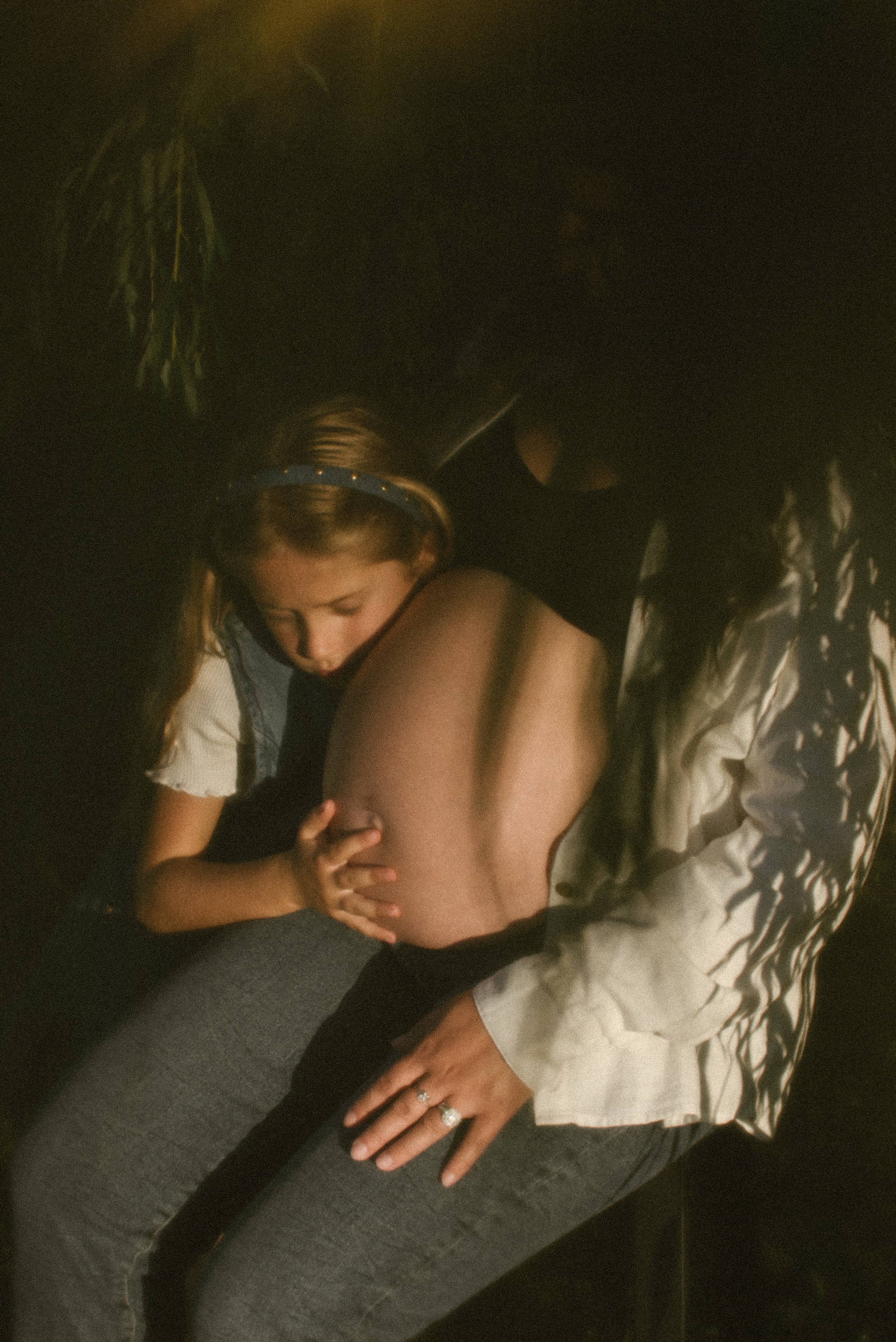 A person receiving a massage from another person in a dimly lit room.
