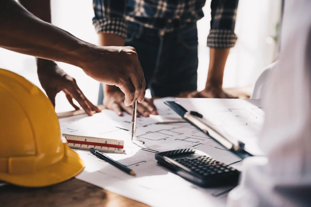 A group of people reviewing and discussing a building plan