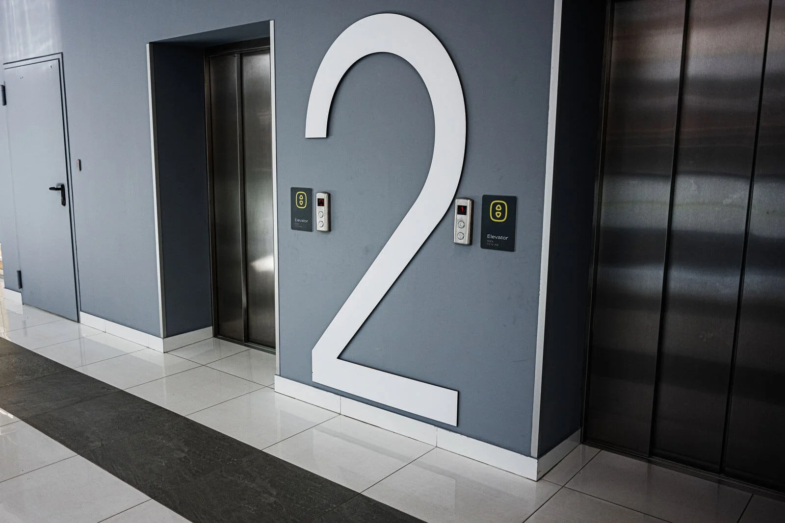 Modern elevator lobby with clear signage and controls