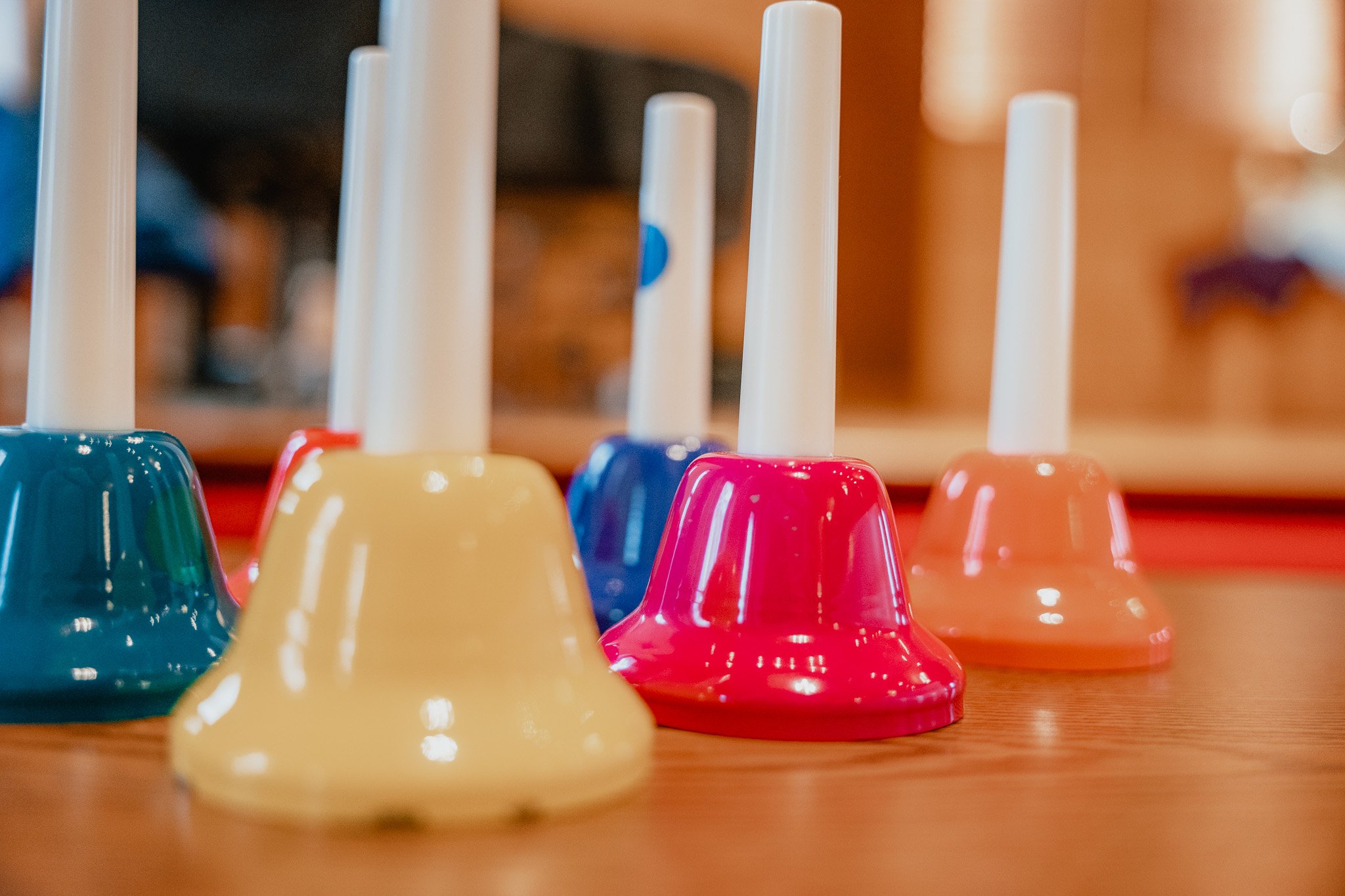 Colorful upside-down plastic dominoes on a wooden surface, with blurred background.