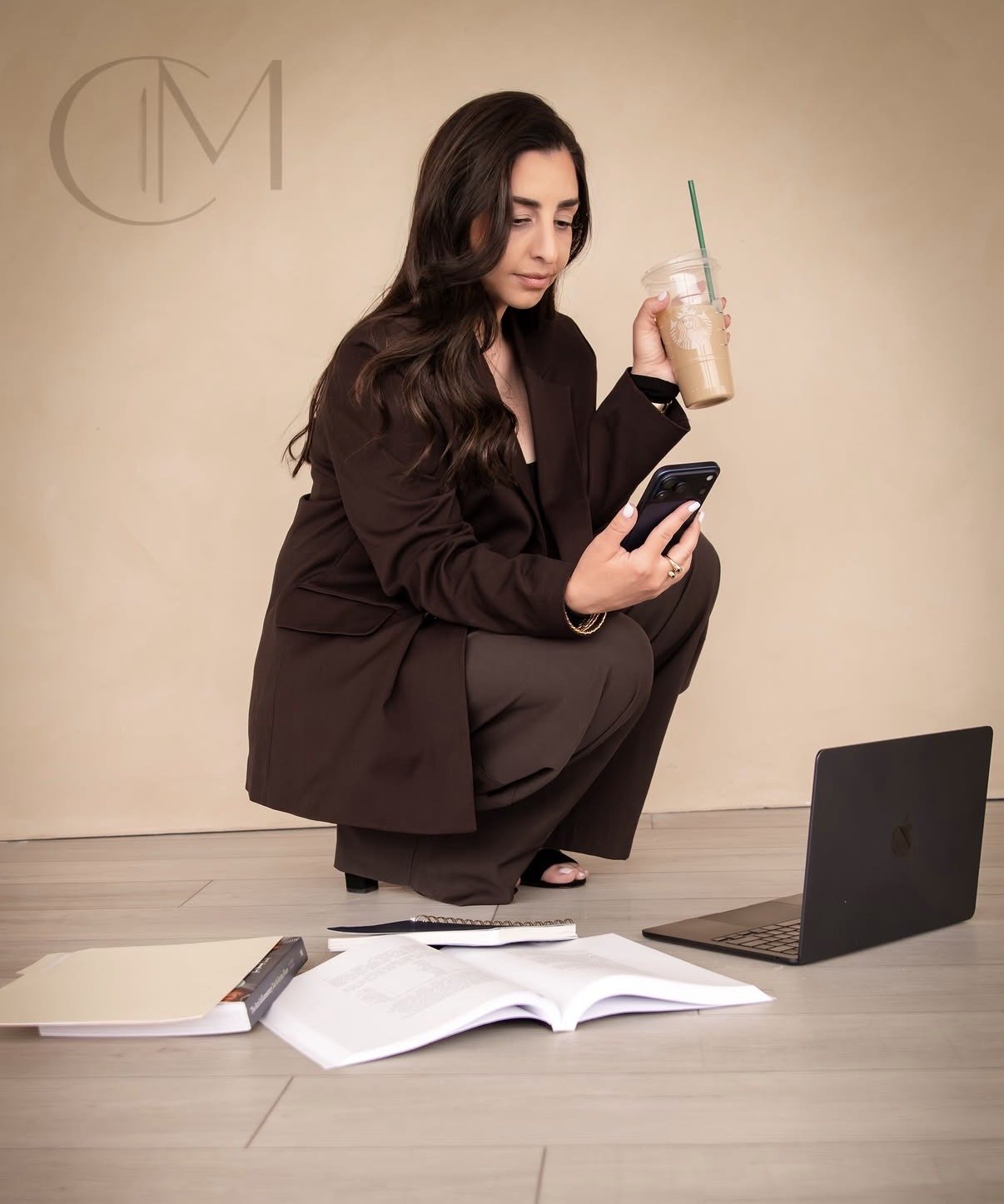 brand photos taken in 480 natural light studio 2 cool modern boss babe style women in brown suit in front of lime wash wall with coffee and phone