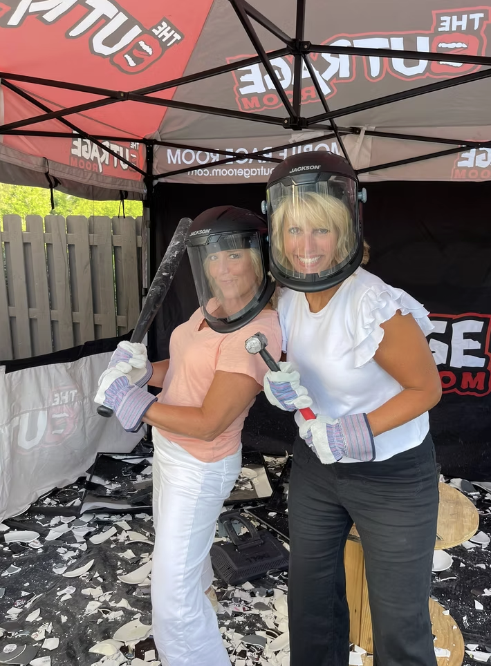 Widows Who Wine members standing with demolition gear
