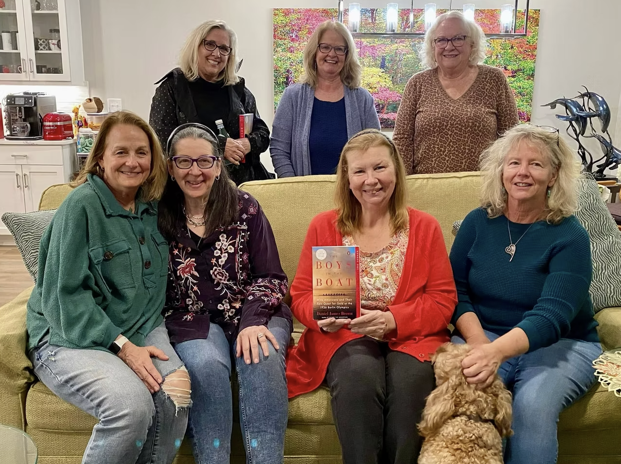 Widows Who Wine members gathered holding a book