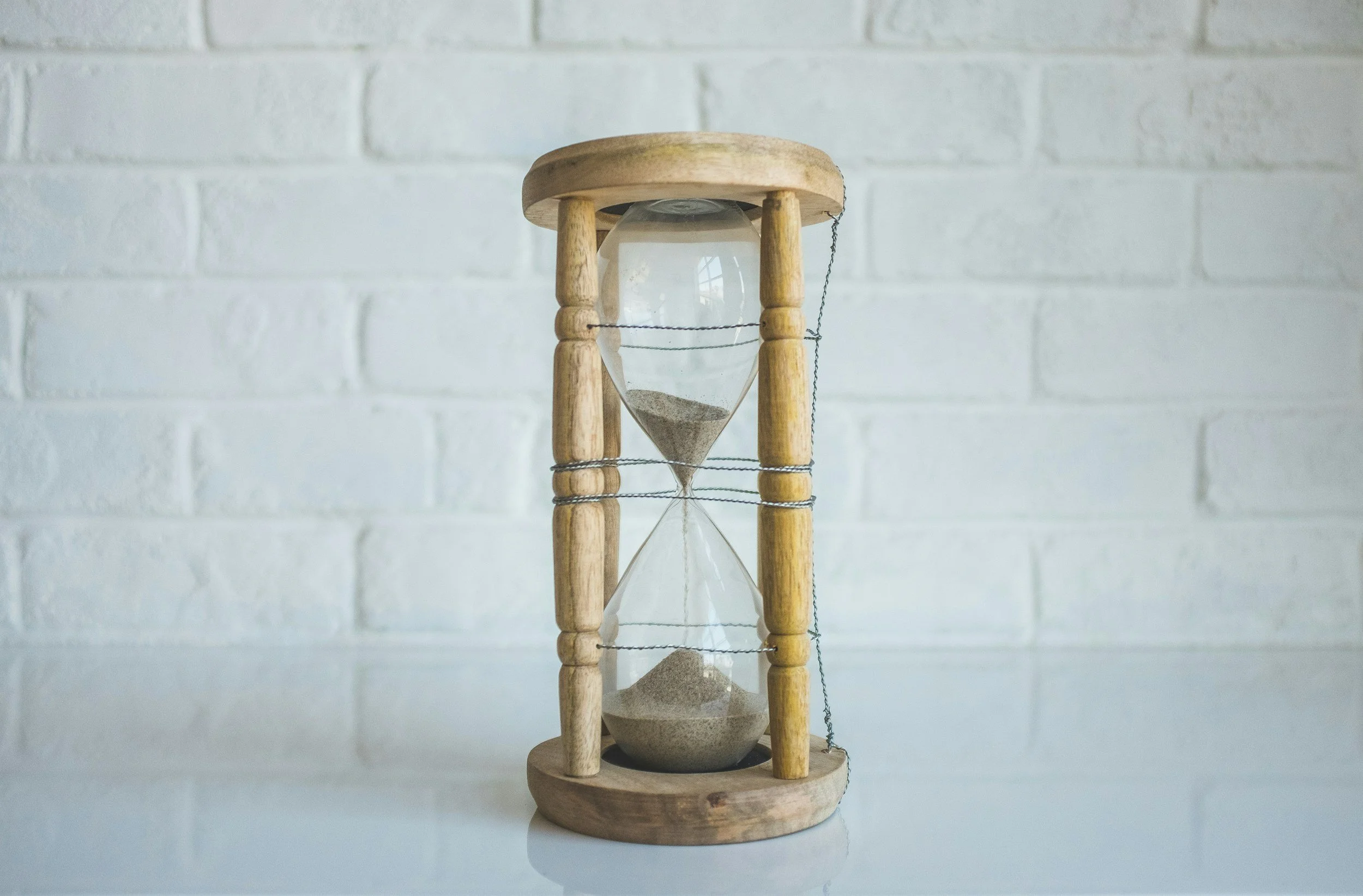 Gold Hourglass with Sand on a white surface