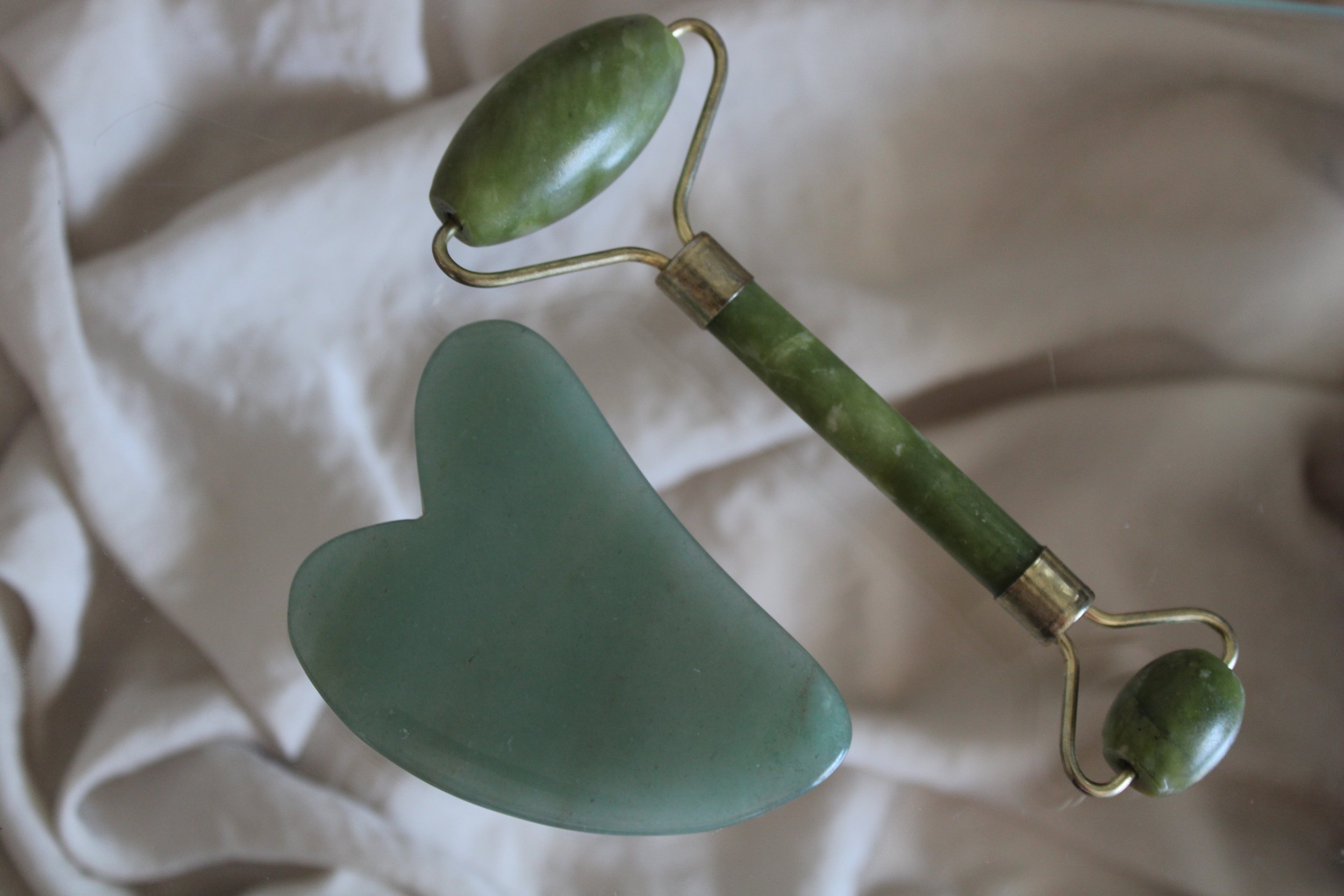 gua sha and jade roller facial massage tools