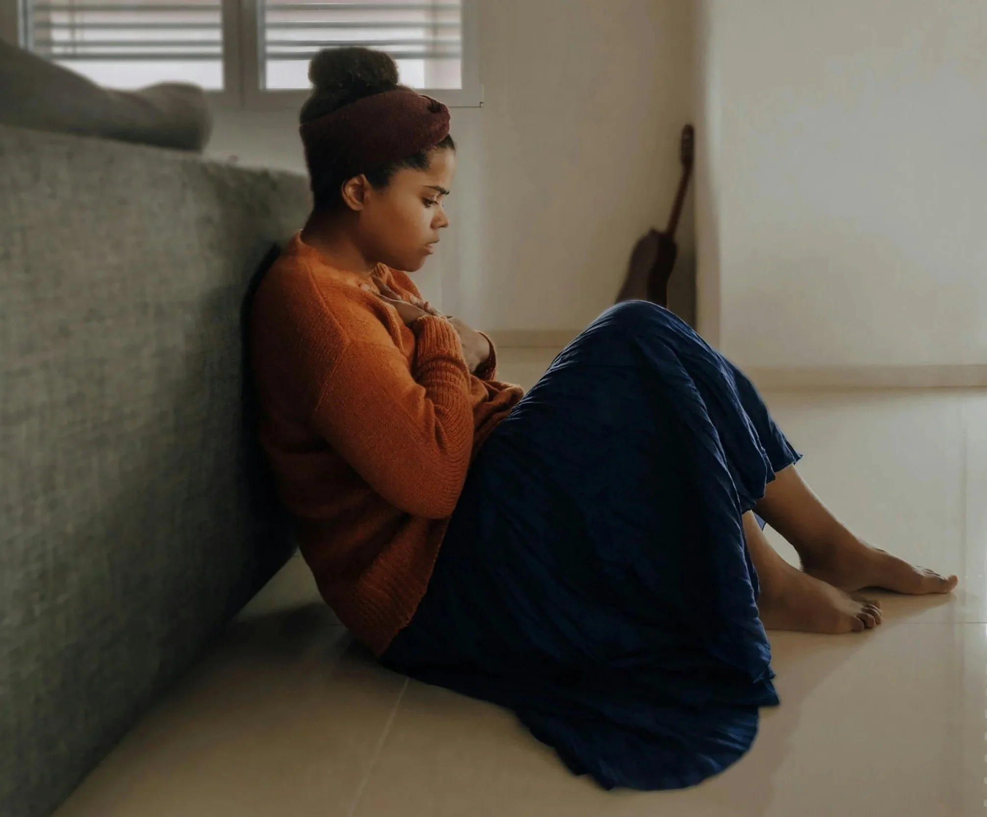 Woman Sitting Leaning Against Couch