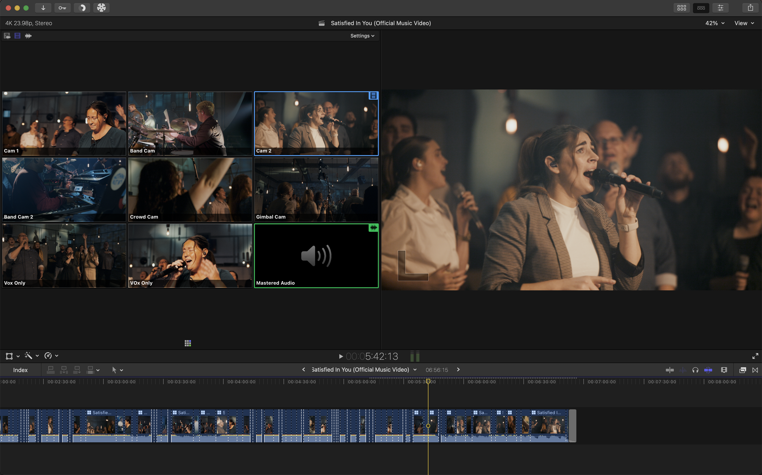 Video editing software interface showing multiple camera angles and scenes of a woman singing at a concert or event, with a focus on her performing with a microphone.