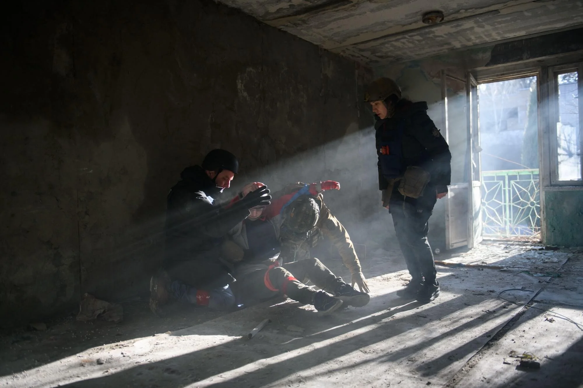 Participants take cover in a building from drones overhead, in a combat simulation held outside Kyiv on Dec. 11, 2025.