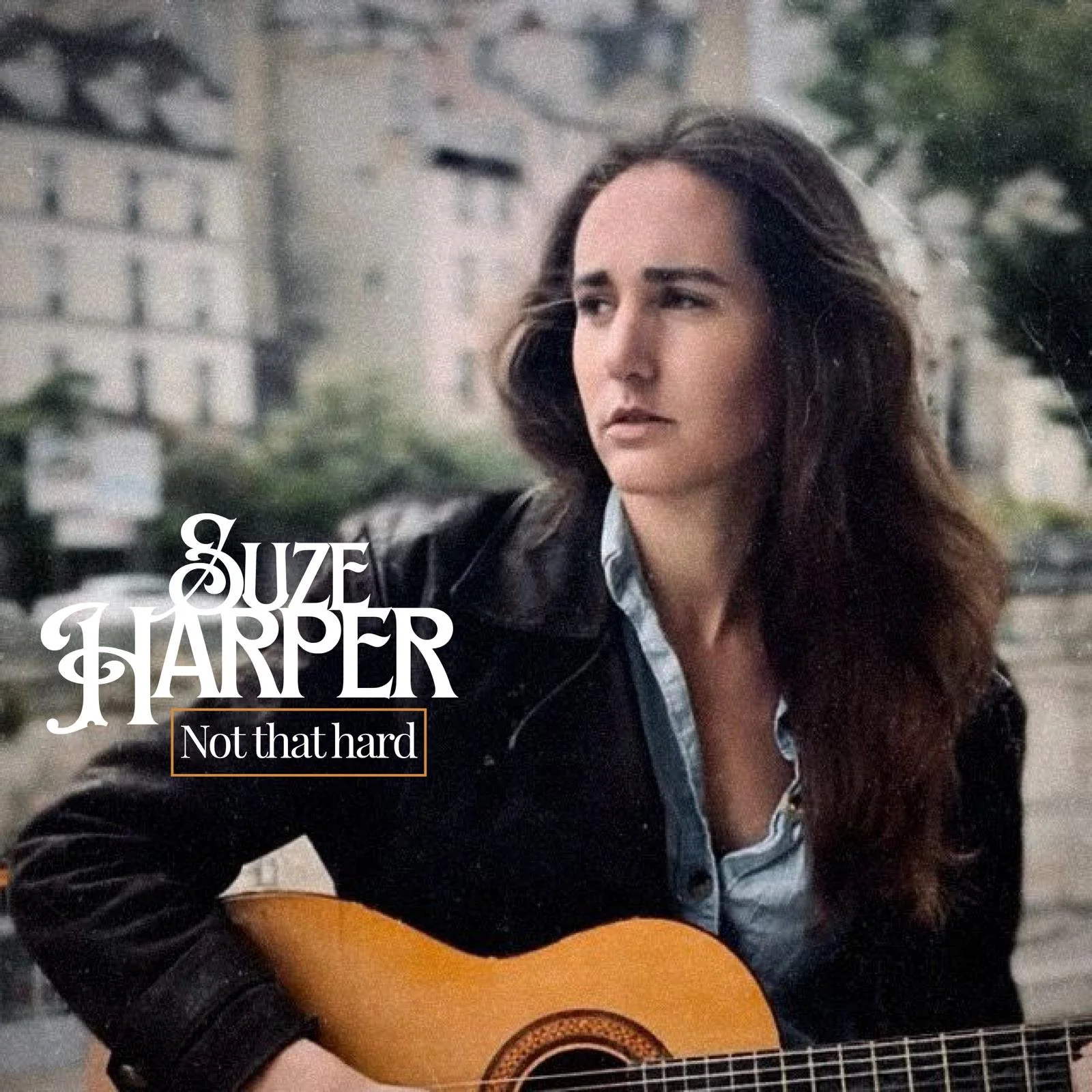 Album cover featuring Suze Harper playing an acoustic guitar outdoors, wearing a leather jacket and looking to the side, with shown text "Suze Harper Not that hard".