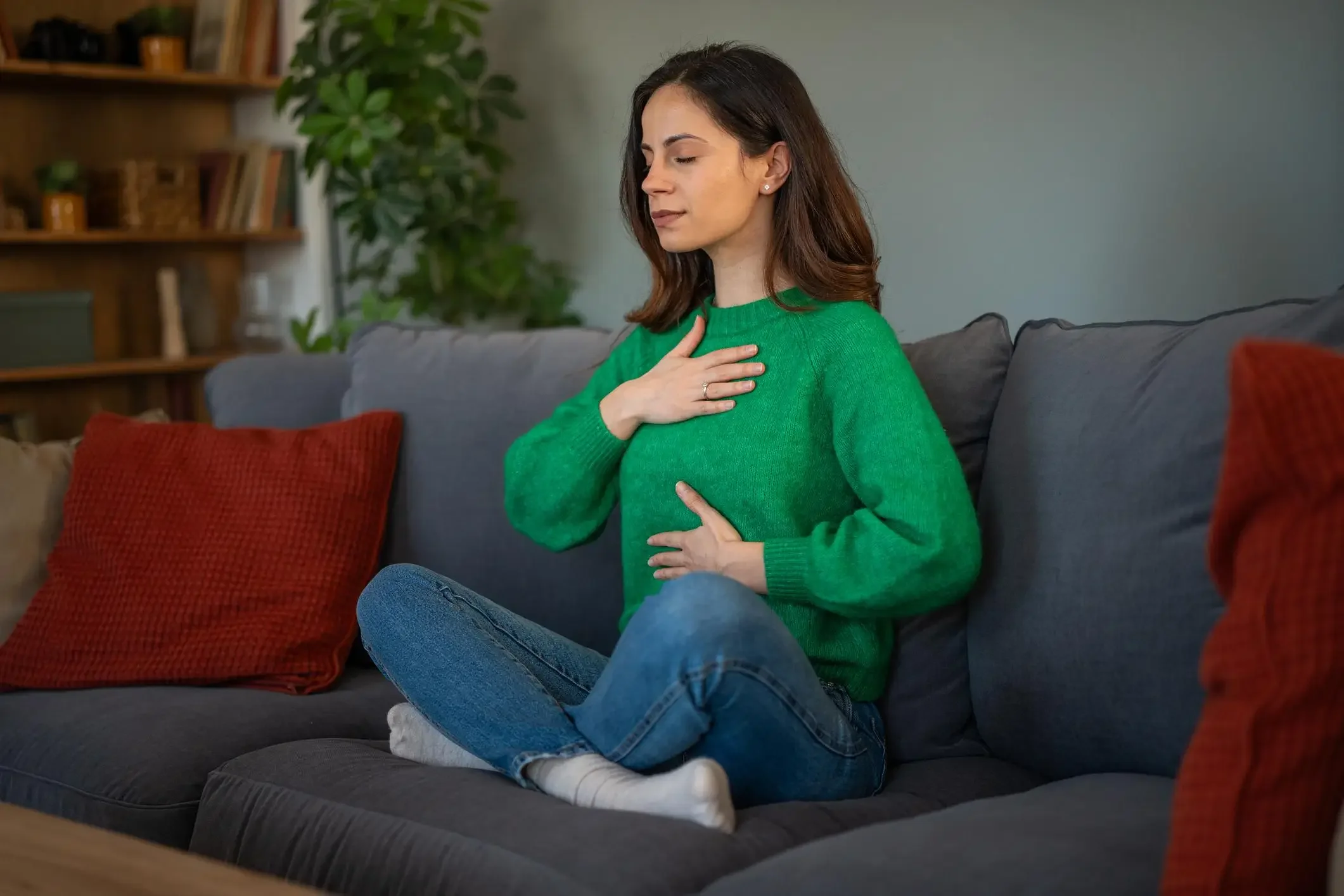 Person in peaceful setting practicing relaxation techniques for chronic pain management