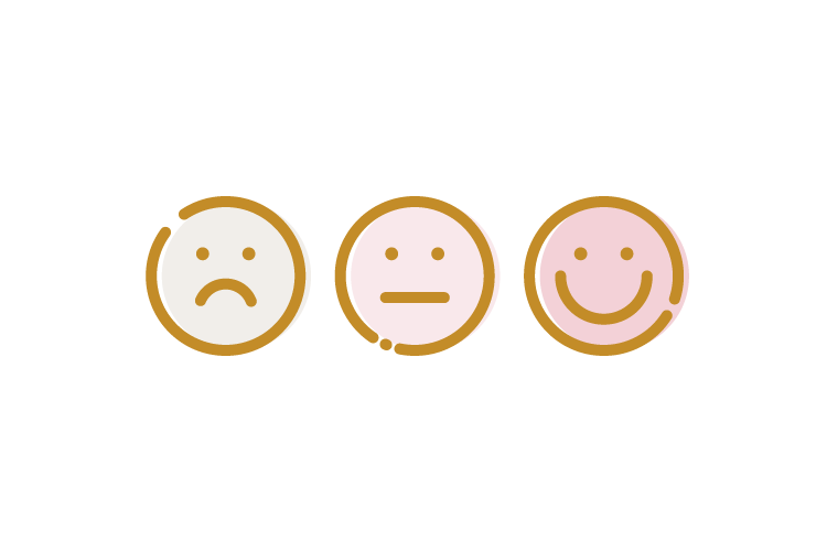 Three smiley face cookies with sad, neutral, and happy expressions in pink, cream, and gold