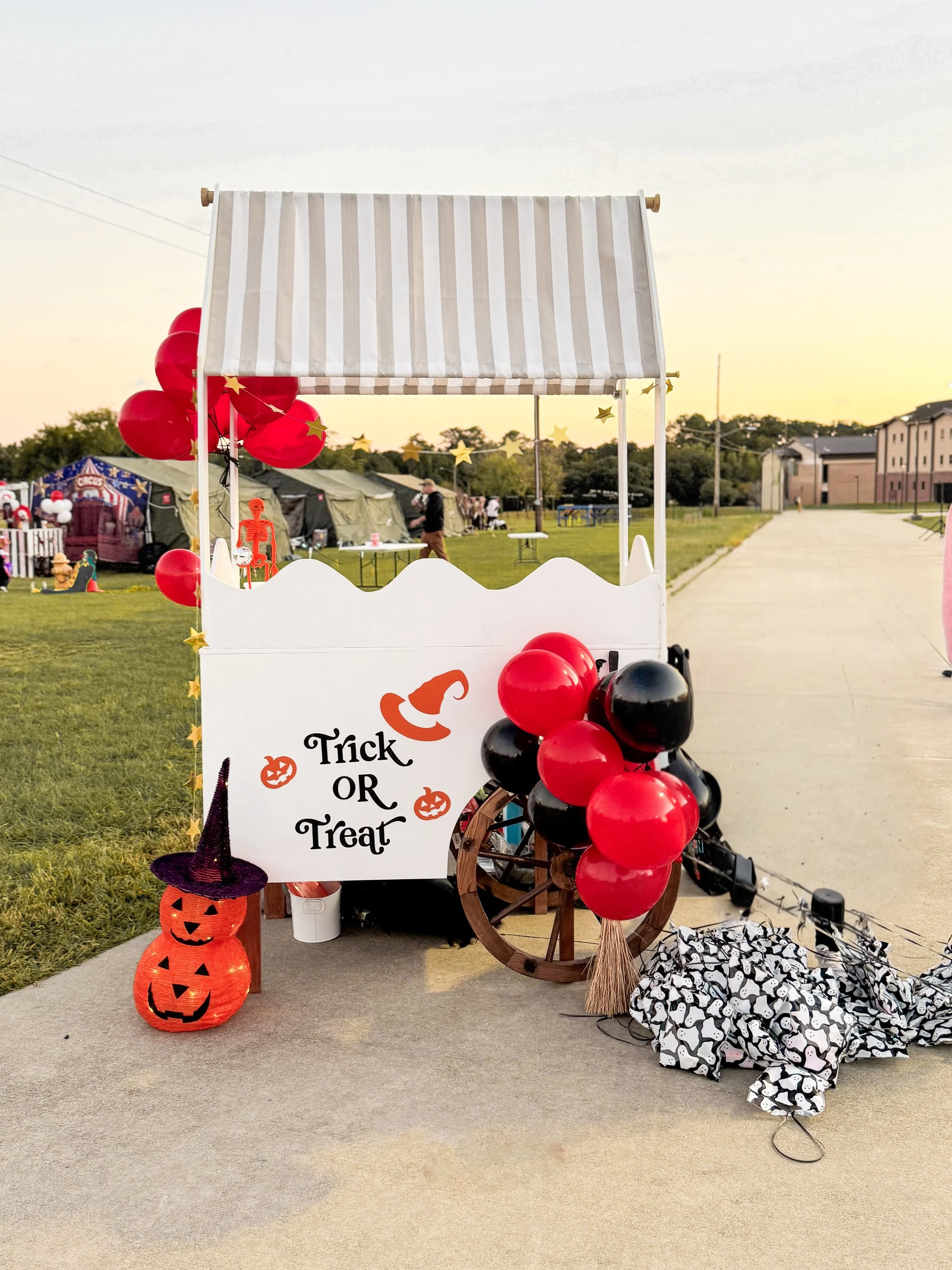 Scenic landscape of a large body of turquoise water with green hills and rugged mountains under cloudy sky.