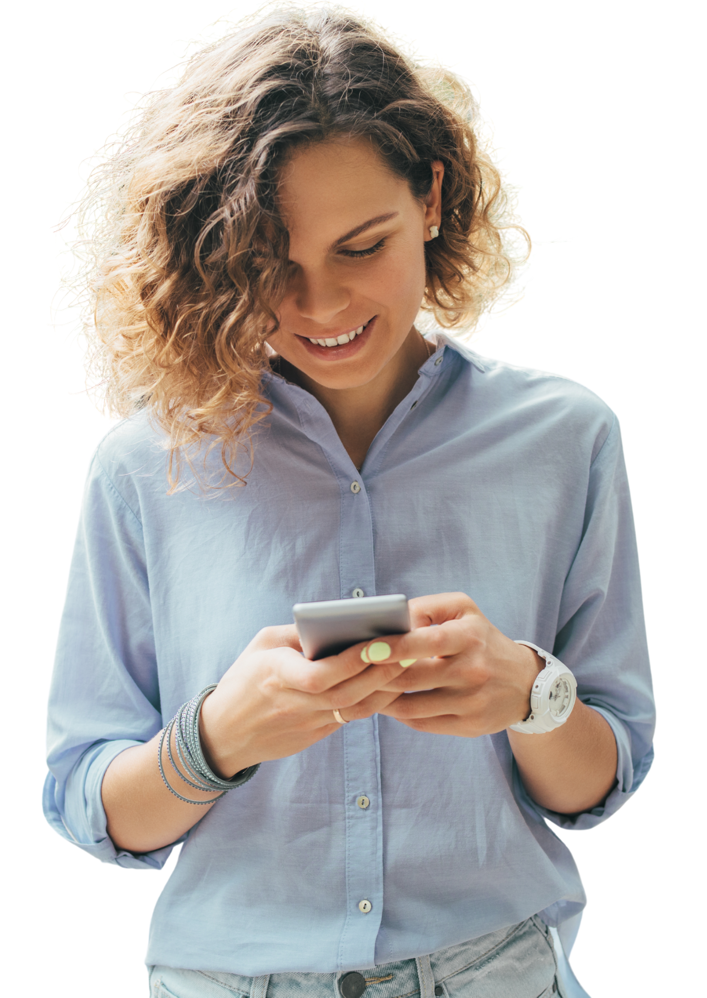 A young woman with curly hair looking at her smartphone and smiling.