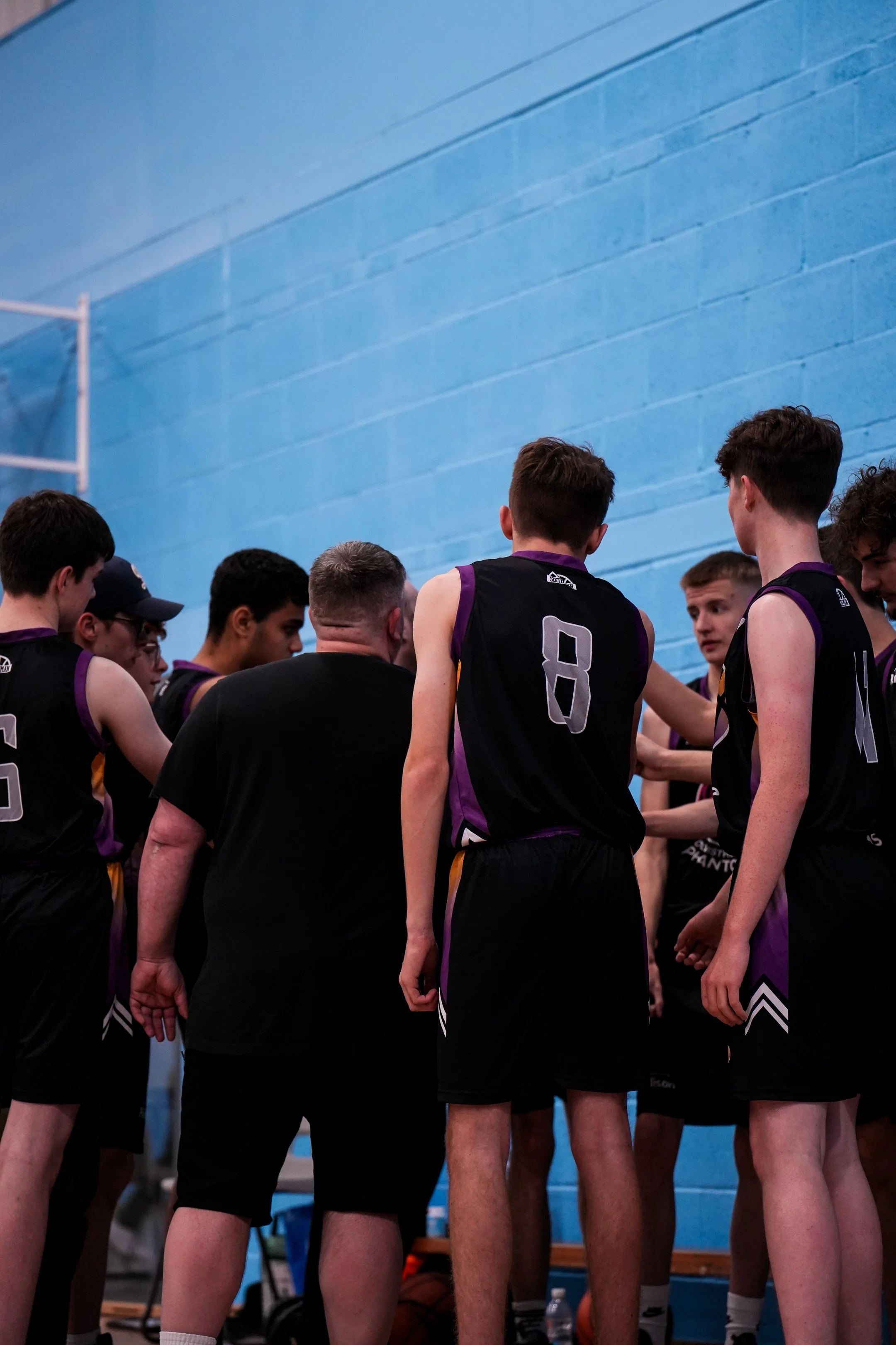 Phantoms basketball players and coach in team talk