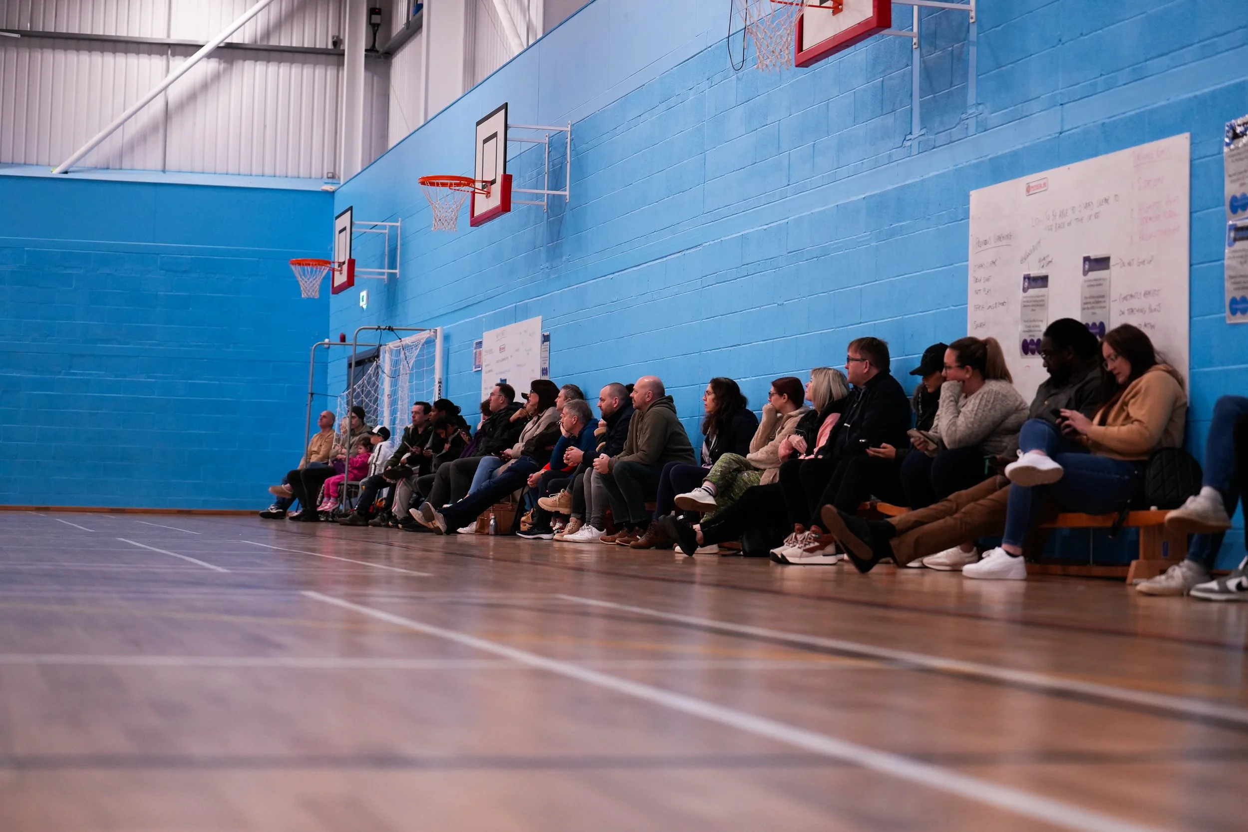 Phantoms basketball game with parents watching on sideline