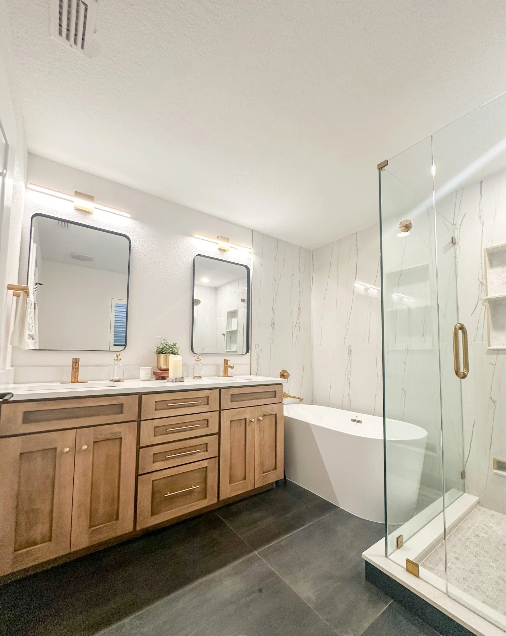 Luxury bathroom build with dual vanity, freestanding tub, and glass shower